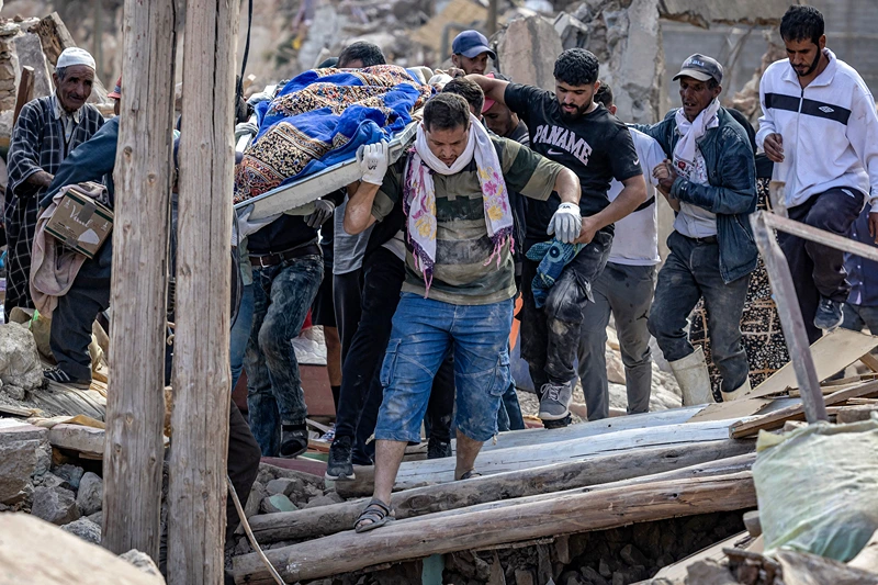 MOROCCO-QUAKE
People carry the remains of a victim of the deadly 6.8-magnitude September 8 earthquake, in the village of Imi N'Tala near Amizmiz in central Morocco on September 10, 2023. Rescuers in Morocco were scrambling on September 9 to reach people trapped under the rubble after a powerful earthquake that killed more than 2,100 people and decimated entire villages. (Photo by FADEL SENNA / AFP) (Photo by FADEL SENNA/AFP via Getty Images)