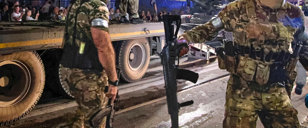 FILE - Members of the Wagner Group military company guard an area as other load their tank onto a truck on a street in Rostov-on-Don, Russia, Saturday, June 24, 2023, prior to leaving an area at the headquarters of the Southern Military District. The U.K. says it will declare Russia’s Wagner mercenary group a banned terrorist organization. British officials say the group remains a threat to global security even after the death of leader Yevgeny Prigozhin. (Vasily Deryugin, Kommersant Publishing House via AP, File)