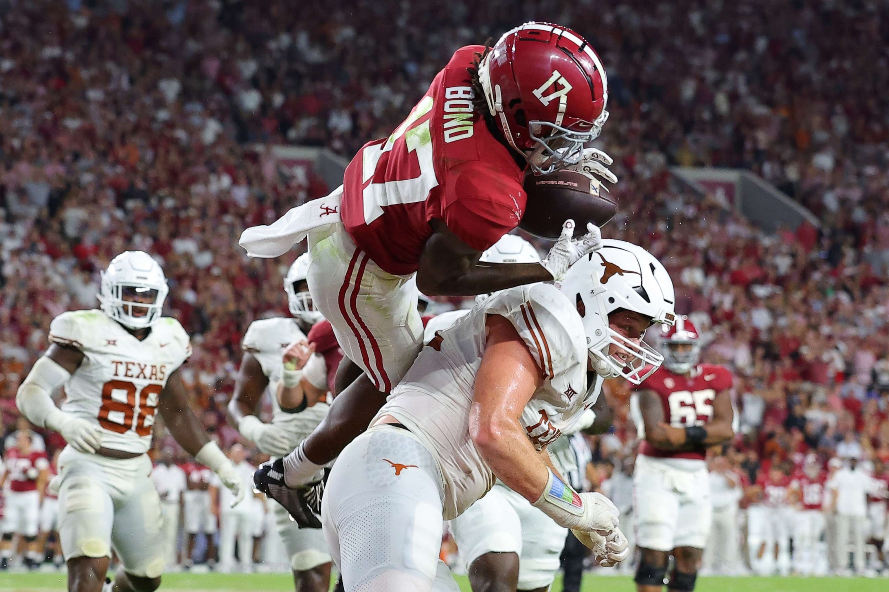 PHOTO: Isaiah Bond #17 of the Alabama Crimson Tide makes the two-point conversion against Ethan Burke #91 of the Texas Longhorns during the fourth quarter at Bryant-Denny Stadium, Sept. 9, 2023, in Tuscaloosa, Ala.