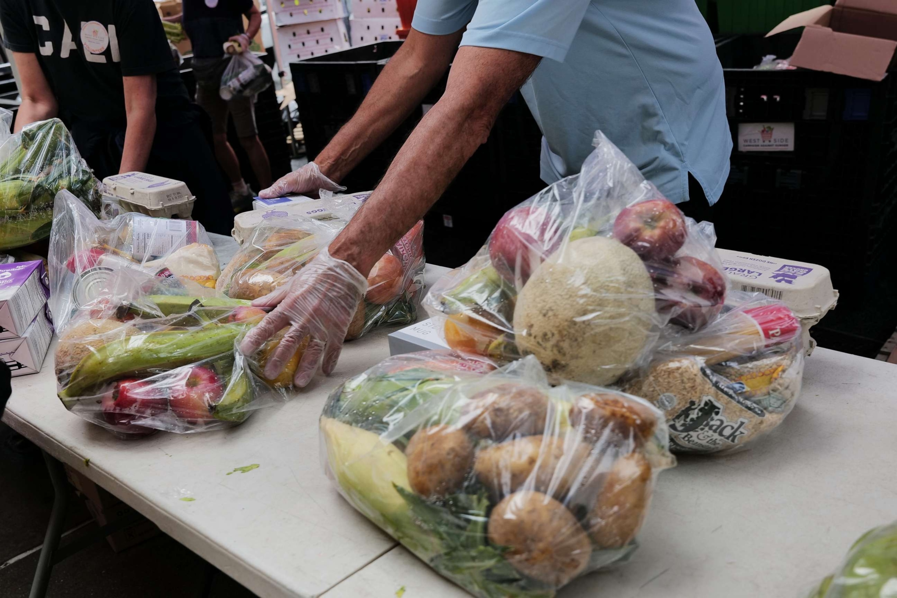 PHOTO: Volunteers and employees with West Side Campaign Against Hunger (WSCAH) distribute food to those in need outside of their Manhattan facility on Aug. 17, 2023 in New York City.
