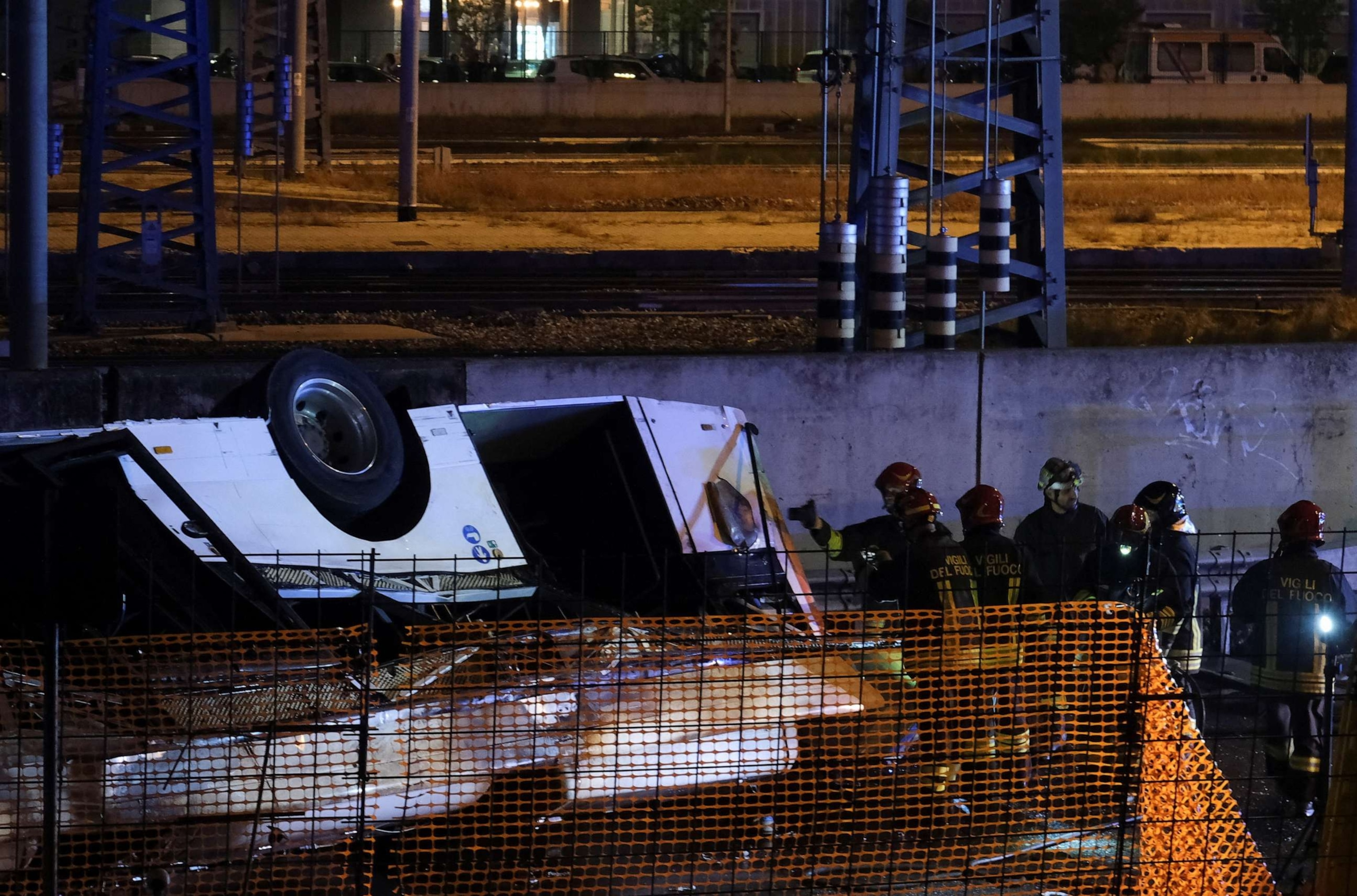 PHOTO: Firefighters work near a coach after it crashed off an overpass in Mestre, Italy, Oct. 3, 2023.