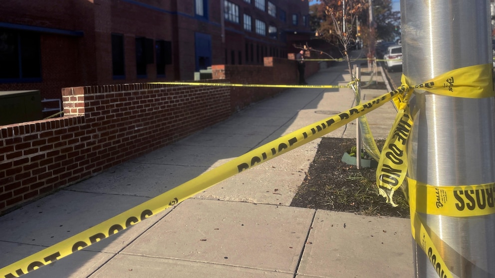 Police tape is placed outside Carver Vocational Technical High School in west Baltimore on Friday, Oct. 27, 2023. Three teenagers were wounded in a shooting outside the high school around the time classes were starting Friday morning. Baltimore police say the victims all received non-life threatening injuries. (AP Photo/Lea Skene)