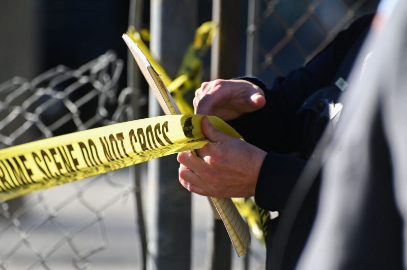 US-CRIME-SHOOTING A San Mateo County Sheriff officer puts up police tape at a crime scene after a shooting at the Spanish Town shops in Half Moon Bay, California, on January 24, 2023. - A suspected gunman was in custody Monday over the killing of seven people in a rural community in northern California, just two days after a mass shooting at a Lunar New Year celebration near Los Angeles. (Photo by Samantha Laurey / AFP) (Photo by SAMANTHA LAUREY/AFP via Getty Images)