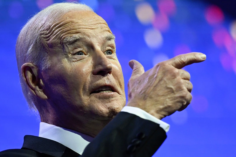 US-POLITICS-BIDEN
US President Joe Biden mimics holding a firearm while speaking about assault weapon ban during the Human Rights Campaign National Dinner at the Washington Convention Center in Washington, DC, on October 14, 2023. (Photo by ANDREW CABALLERO-REYNOLDS / AFP) (Photo by ANDREW CABALLERO-REYNOLDS/AFP via Getty Images)