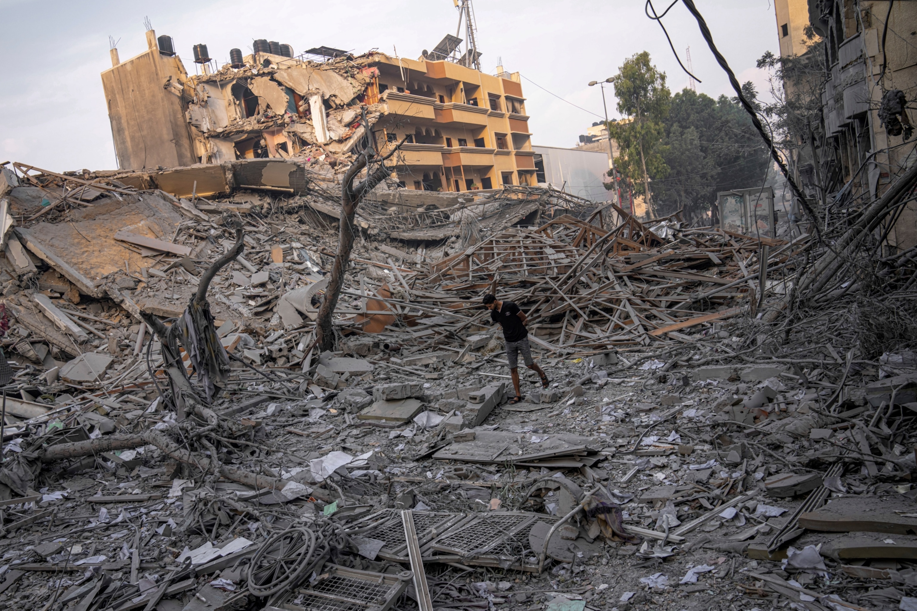 PHOTO: Palestinians inspect the rubble of a building after it was struck by an Israeli airstrike, in Gaza City, Oct. 8, 2023.