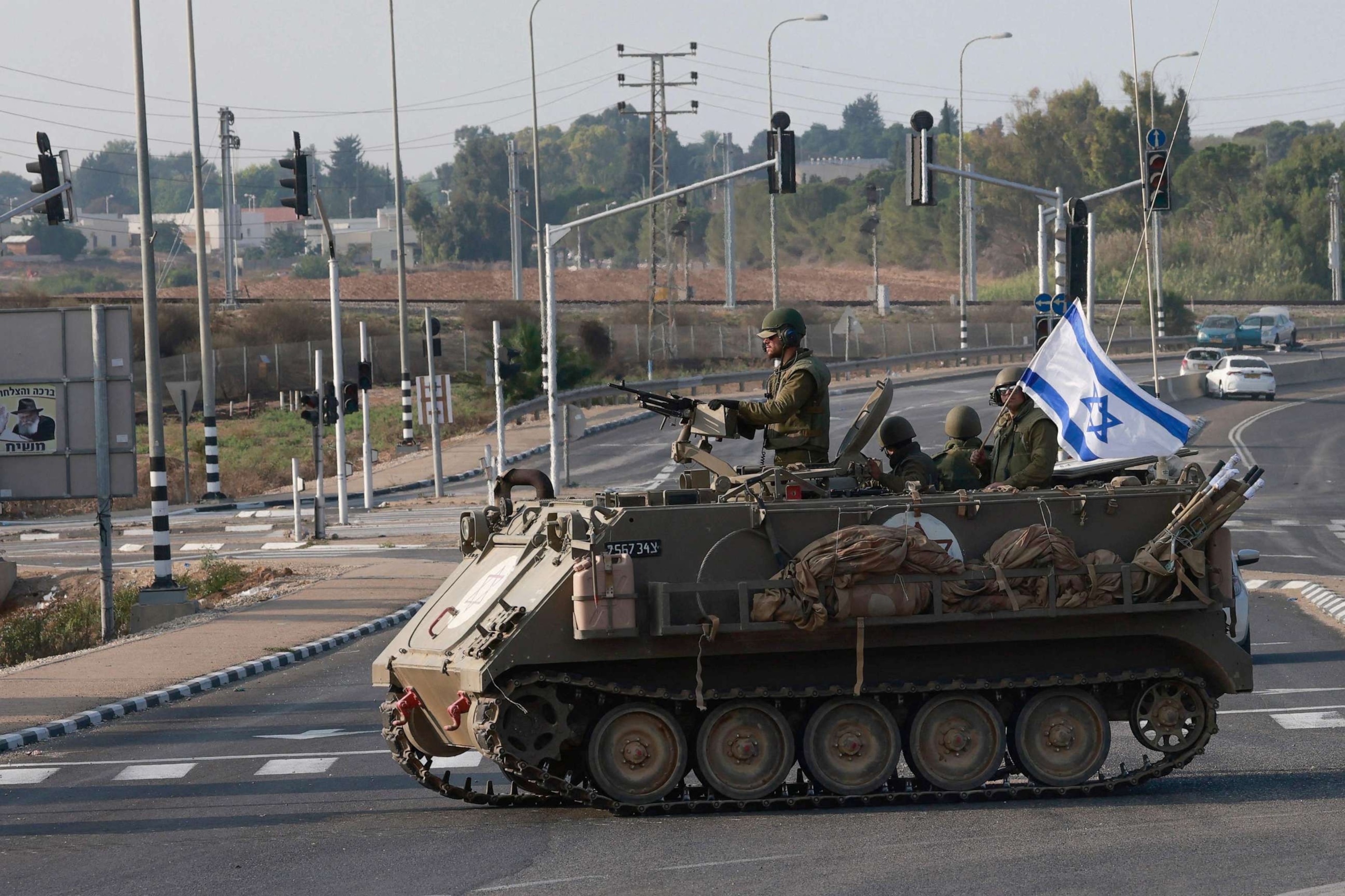 PHOTO: Israeli forces cross a main road in their armoured personnel carrier (APC) as additional troops are deployed near the southern city of Sderot on Oct. 8, 2023.