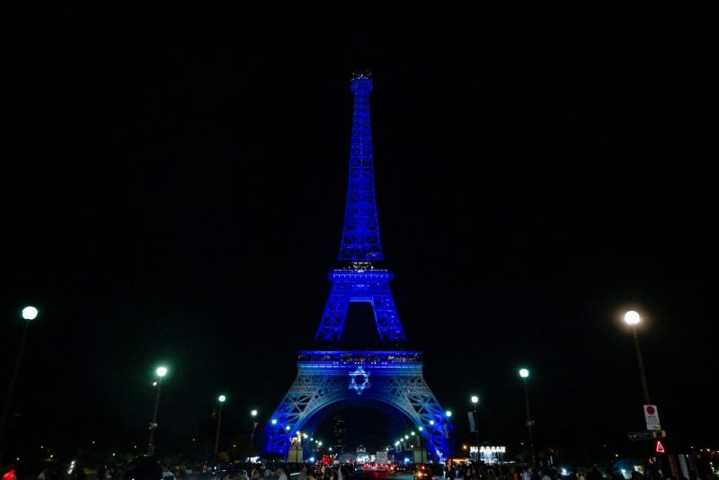 This photograph taken on October 9, 2023 shows the Eiffel Tower illuminated with the Star of David and the colours of national flag of Israel, in tribute to the victims of the recent Hamas attacks. (Photo by JULIEN DE ROSA / AFP) / RESTRICTED TO EDITORIAL USE - MANDATORY MENTION OF THE ARTIST UPON PUBLICATION - TO ILLUSTRATE THE EVENT AS SPECIFIED IN THE CAPTION (Photo by JULIEN DE ROSA/AFP via Getty Images)