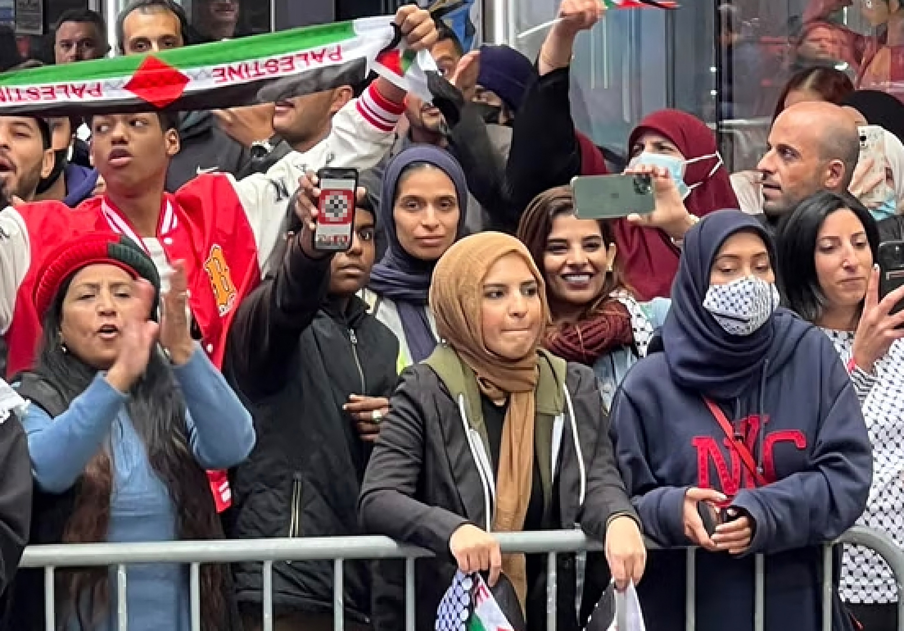PHOTO: A protestor in Times Square shows a swastika on his mobile phone to pro-Israel supporters during a demonstration in New York City, Oct. 8, 2023.