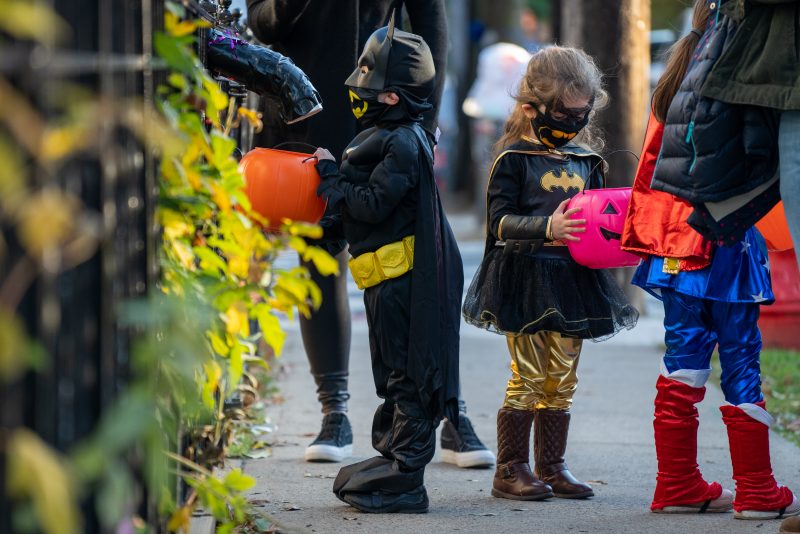 NEW YORK, NY - OCTOBER 31: Children receive treats by candy chutes while trick-or-treating for Halloween in Woodlawn Heights on October 31, 2020 in New York City. The CDC shared on their website alternative ways to still celebrate the holiday while being safe. (Photo by David Dee Delgado/Getty Images)