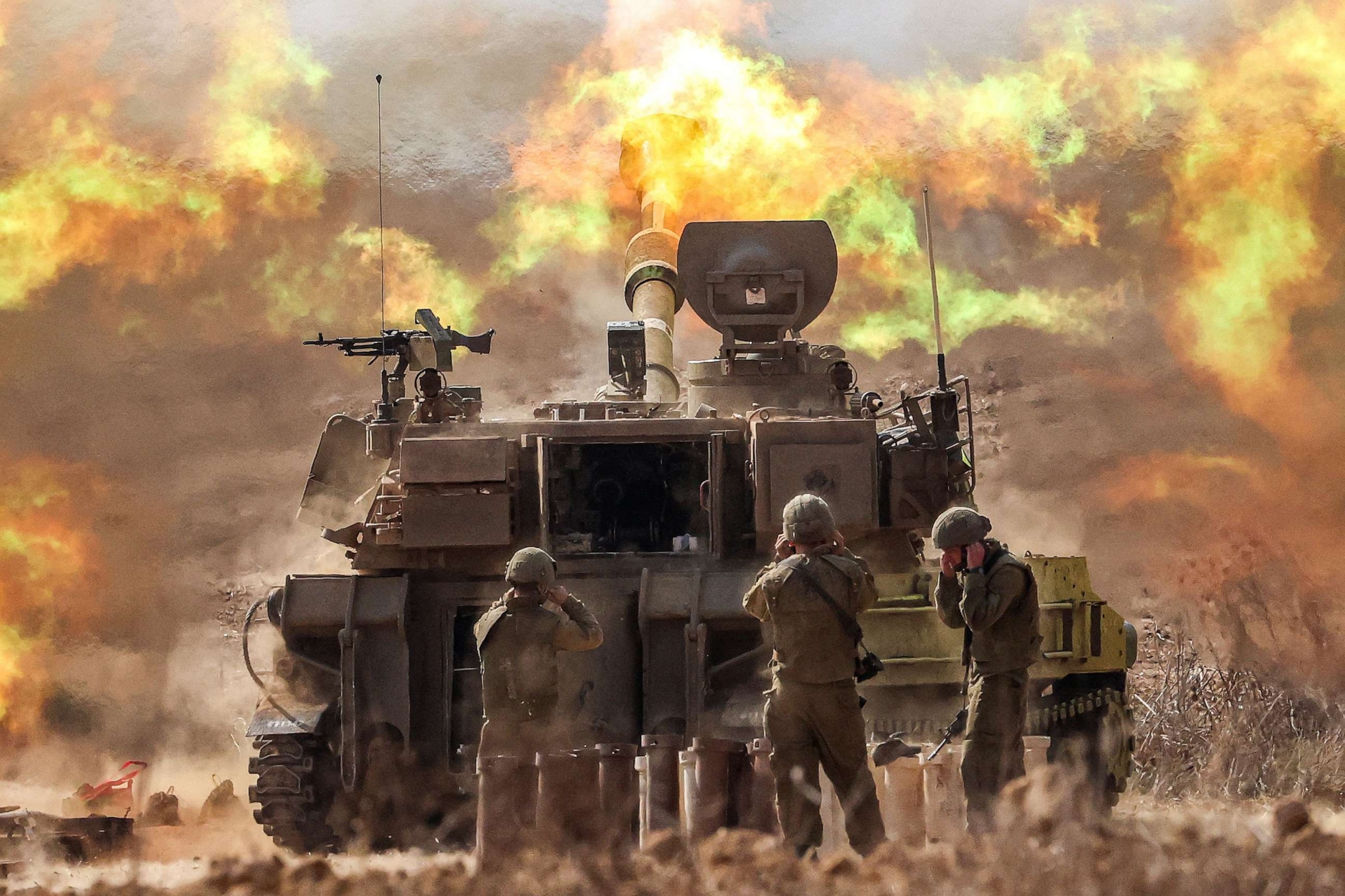 PHOTO: An Israeli army self-propelled howitzer fires rounds near the border with Gaza in southern Israel, Oct. 11, 2023.
