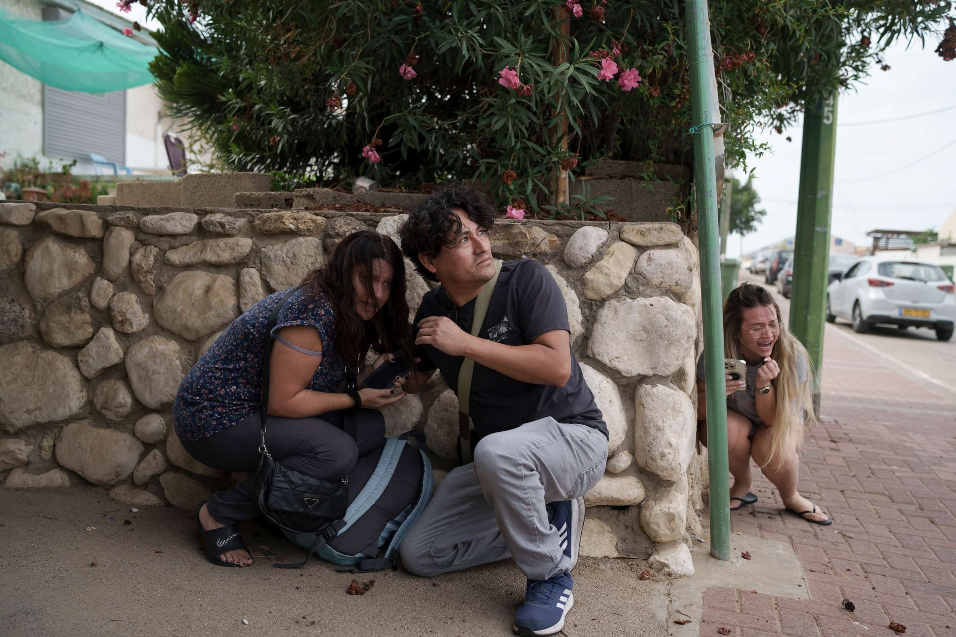 PHOTO: Israelis take cover from the incoming rocket fire from the Gaza Strip in Ashkelon, southern Israel, Oct. 11, 2023.