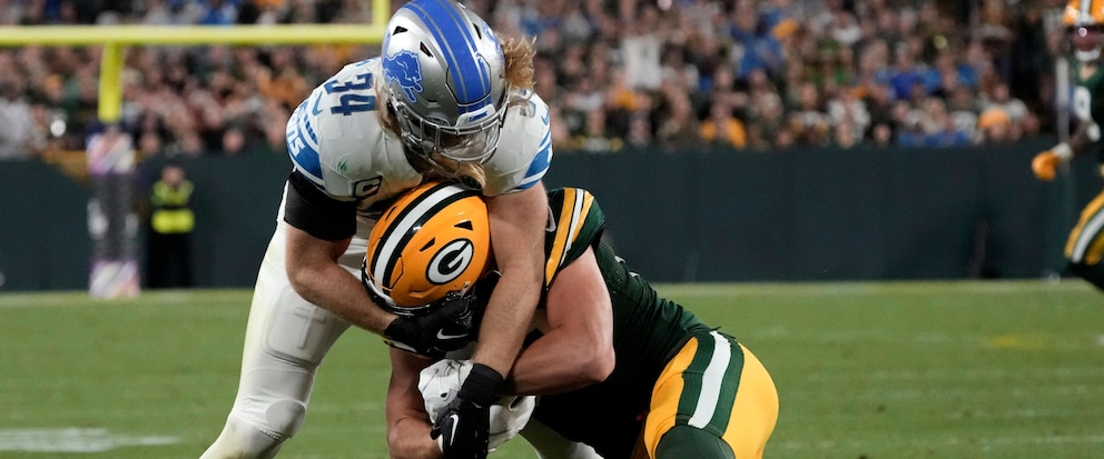 Green Bay Packers tight end Luke Musgrave (88) is tackled by Detroit Lions linebacker Alex Anzalone (34) after catching a pass during the first half of an NFL football game, Thursday, Sept. 28, 2023, in Green Bay, Wis. (AP Photo/Morry Gash)