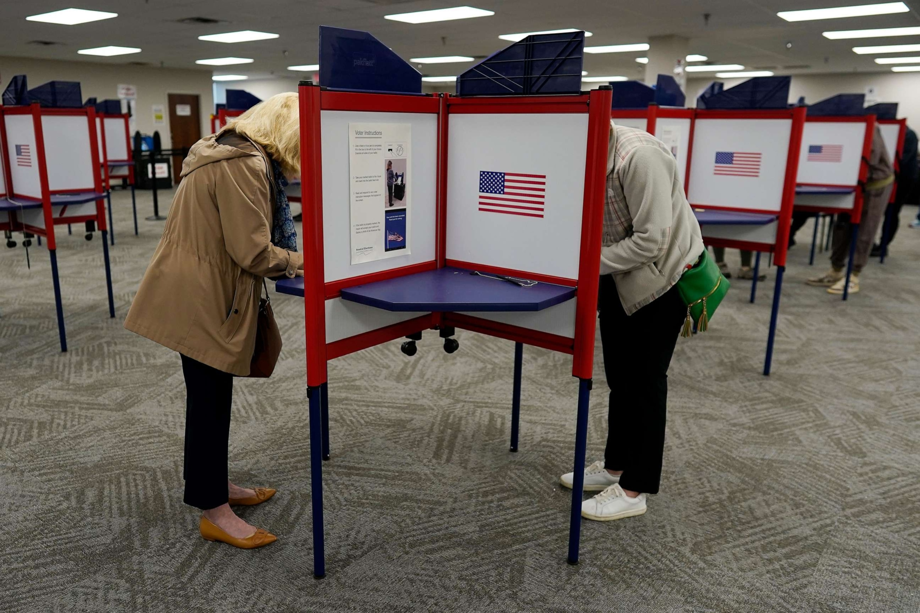 PHOTO: Voters stand in partitioned booths to fill out their ballots during early in-person voting at the Hamilton County Board of Elections in Cincinnati, Oct. 11, 2023.