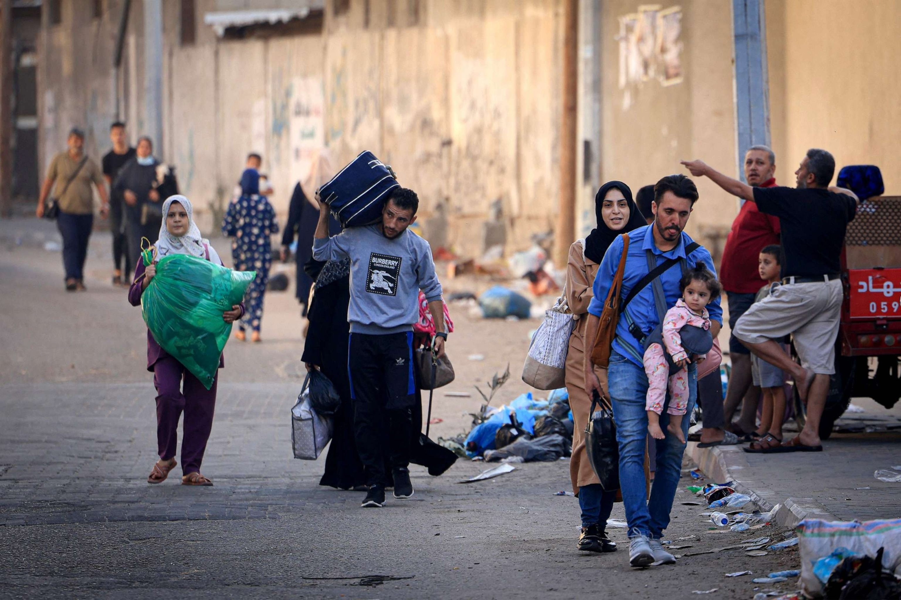 PHOTO: Palestinians carrying their belongings, flee to safer areas in Gaza City after Israeli air strikes, on Oct. 13, 2023.