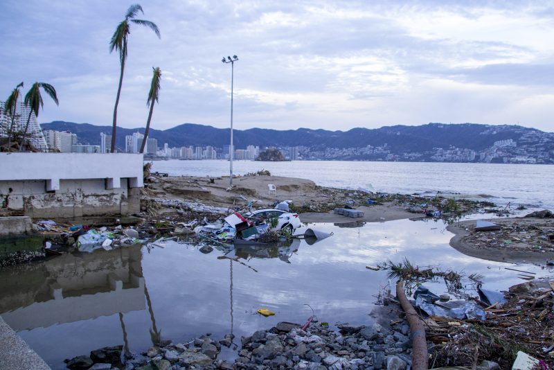 ACAPULCO, MEXICO - OCTOBER 25: A car is seen sunk after hurricane Otis hit Acapulco on October 25, 2023 in Acapulco, Mexico. Otis made landfall through the coast of Acapulco around midnight of October 25 as a category 5 storm. President Lopez Obrador reported that communications were interrupted in the city, power lines were down affecting almost a million people, infrastructure is severely damaged and the roads to the port present important damages. Hurricane Otis degraded to category 2 after reaching land. (Photo by Oscar Guerrero Ramirez/Getty Images)