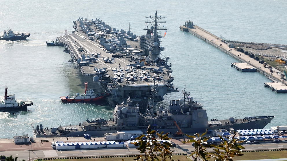 U.S. nuclear-powered aircraft carrier USS Ronald Reagan is escorted as it arrives in Busan, South Korea, Thursday, Oct. 12, 2023. (Kang Duck-chul/Yonhap via AP)