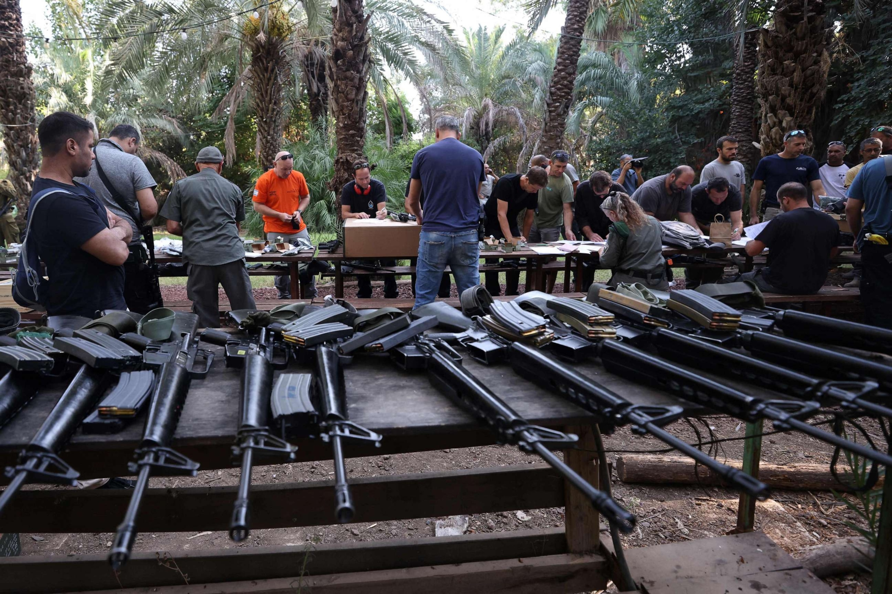 PHOTO: Israelis arrive at a weapons distribution point for people allowed to carry arms, at the Ayyelet HaShahar Kibbutz, in northern Israel, near the Lebanese border on October 12, 2023.