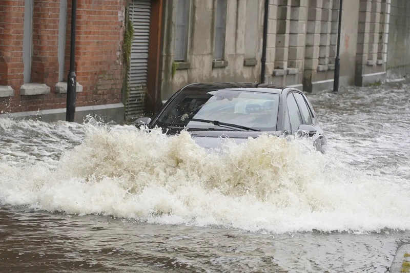 11 | A car drives through flood water on Canal Quay in Newry Town, Co Down, which has been swamped by floodwater as the city's canal burst its banks amid heavy rainfall, Wednesday Nov. 1, 2023. Dozens of businesses were engulfed in the floods, with widespread damage caused to buildings, furnishings and stock. (Brian Lawless/PA via AP)