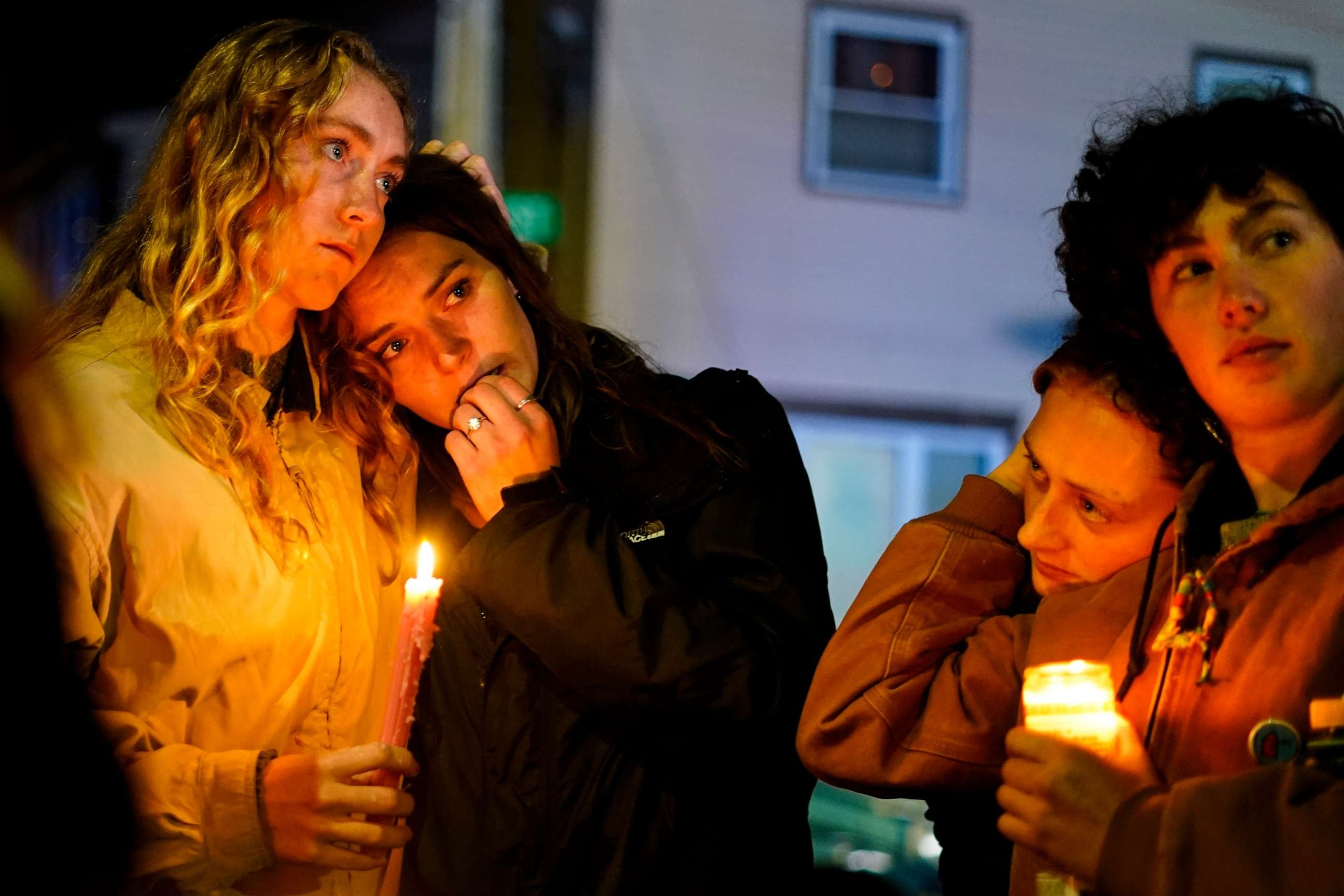 PHOTO: People linger after a vigil for the victims of Wednesday's mass shootings, Sunday, Oct. 29, 2023, outside the Basilica of Saints Peter and Paul in Lewiston, Maine.