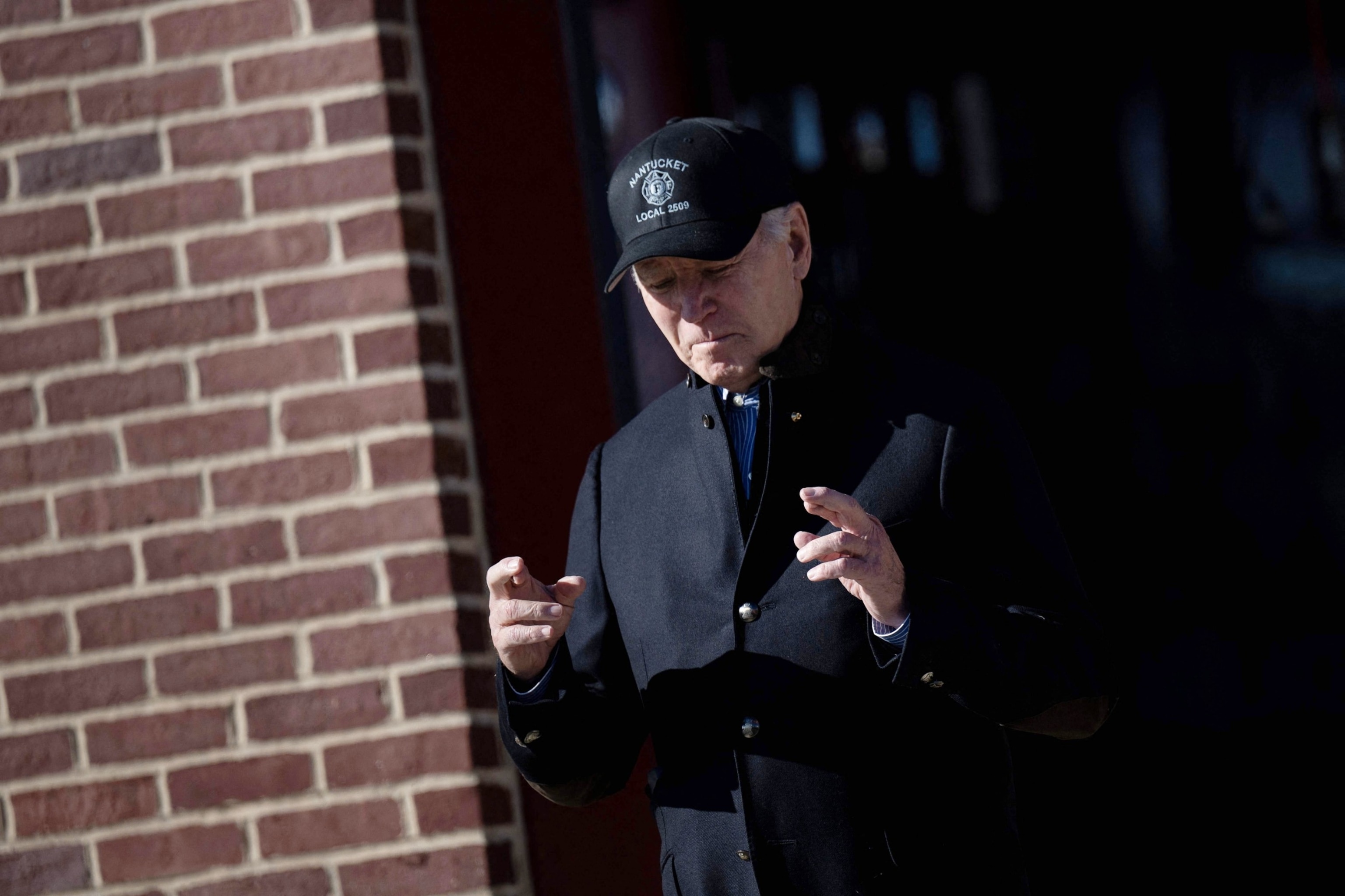 PHOTO: President Joe Biden crosses his fingers while responding to a question about the release of Hamas hostages after a visit to the Nantucket Fire Department on Thanksgiving November 23, 2023 in Nantucket, Mass. 