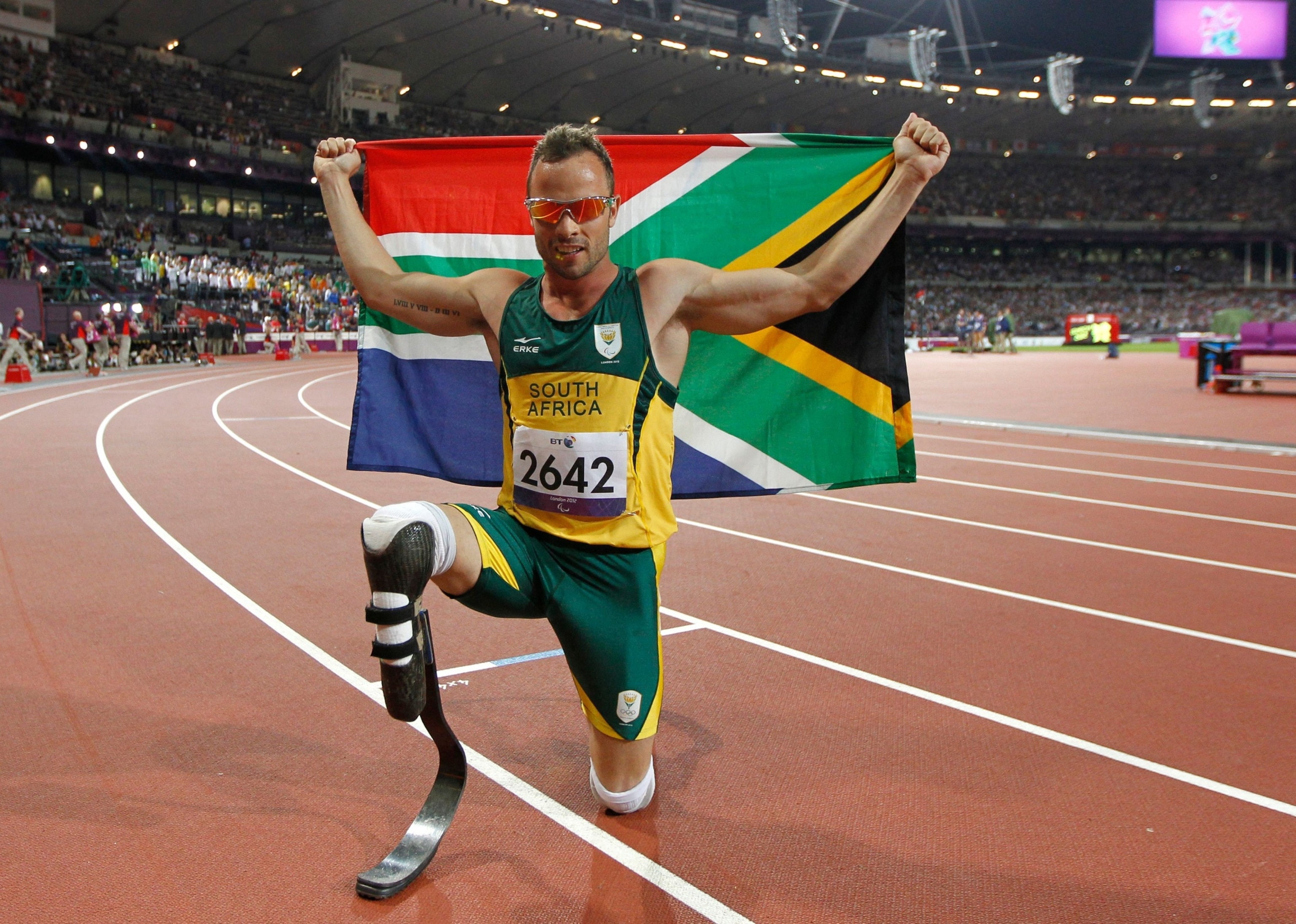 PHOTO: South Africa's Oscar Pistorius poses with photographs with a national flag after winning gold in the men's 400m - T44 final during the athletics competition at the London 2012 Paralympic Games at the Olympic Stadium in London on Sept. 8, 2012.