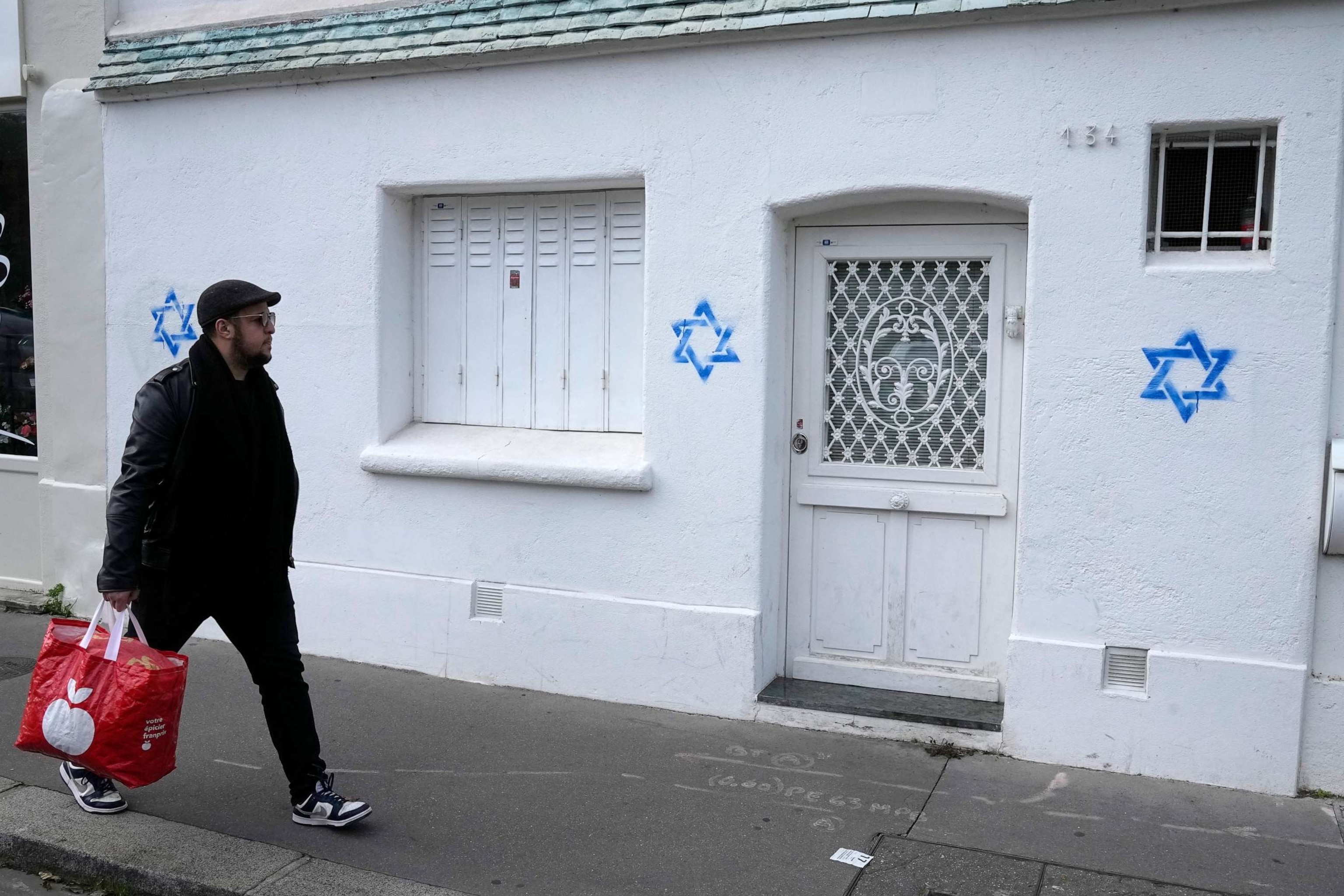 PHOTO: A man walks by Star of David symbols tagged on a wall Tuesday, Oct. 31, 2023, in Paris.