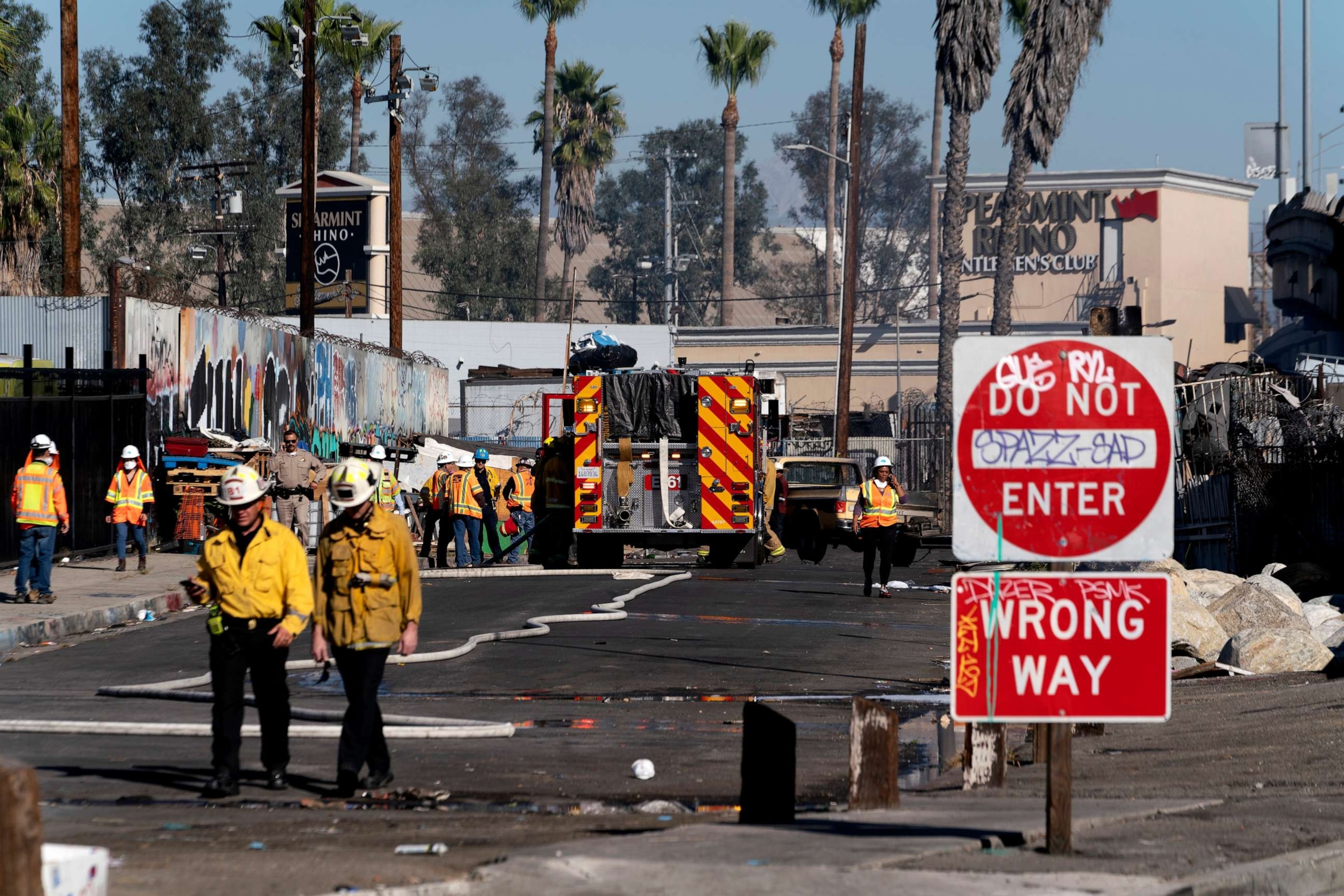 PHOTO: Los Angeles firefighters mop up damage from a fire that severely damaged a section of Interstate 10 in an industrial zone near downtown Los Angeles on Nov. 11, 2023.