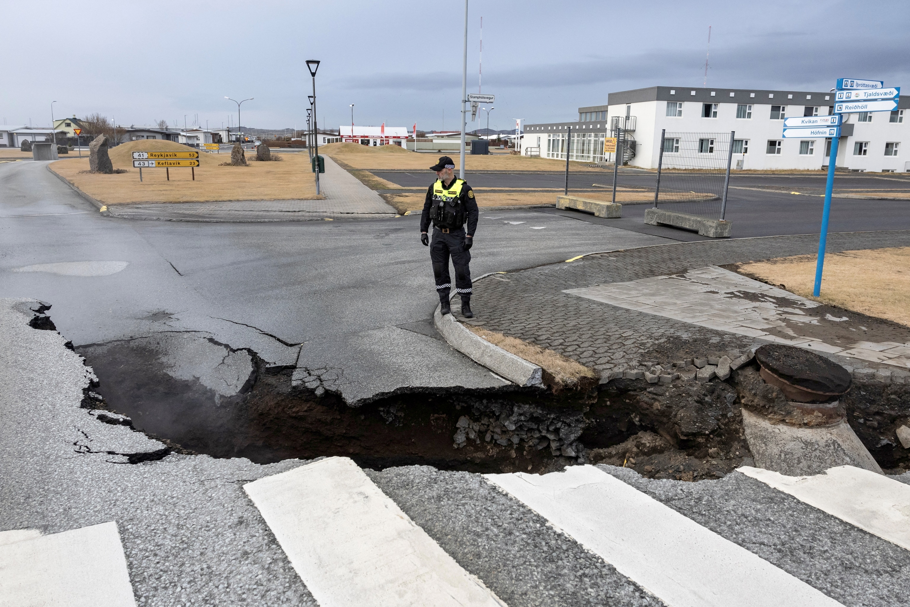 PHOTO: A police officer stands by the crack in a road in the fishing town of Grindavik, which was evacuated due to volcanic activity, in Iceland, November 15, 2023.