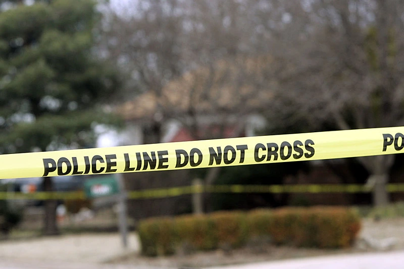 PARK CITY, KS - FEBRUARY 26: Police tape hangs across the street in front of the house that Dennis Rader lives in February 26, 2005 in Park City, Kansas. Rader is the suspect whom police have arrested on suspicion of first-degree murder in connection with the 10 deaths now tied to the serial killer known as BTK. (Photo by Larry W. Smith/Getty Images)