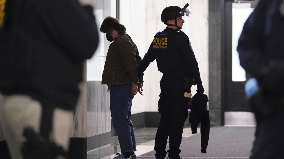 A Department of Homeland Security officer detains a protester during a sit-in demanding a cease-fire in the Israel-Hamas war on Monday, Nov. 13, 2023, at the Oakland Federal Building in Oakland, Calif. (AP Photo/Godofredo A. Vásquez)