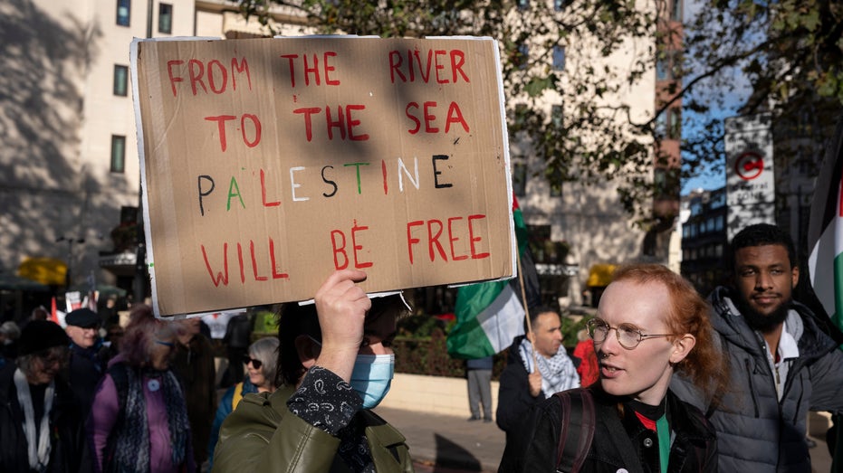 Anti-Israel protest with "from the river to the sea..." sign