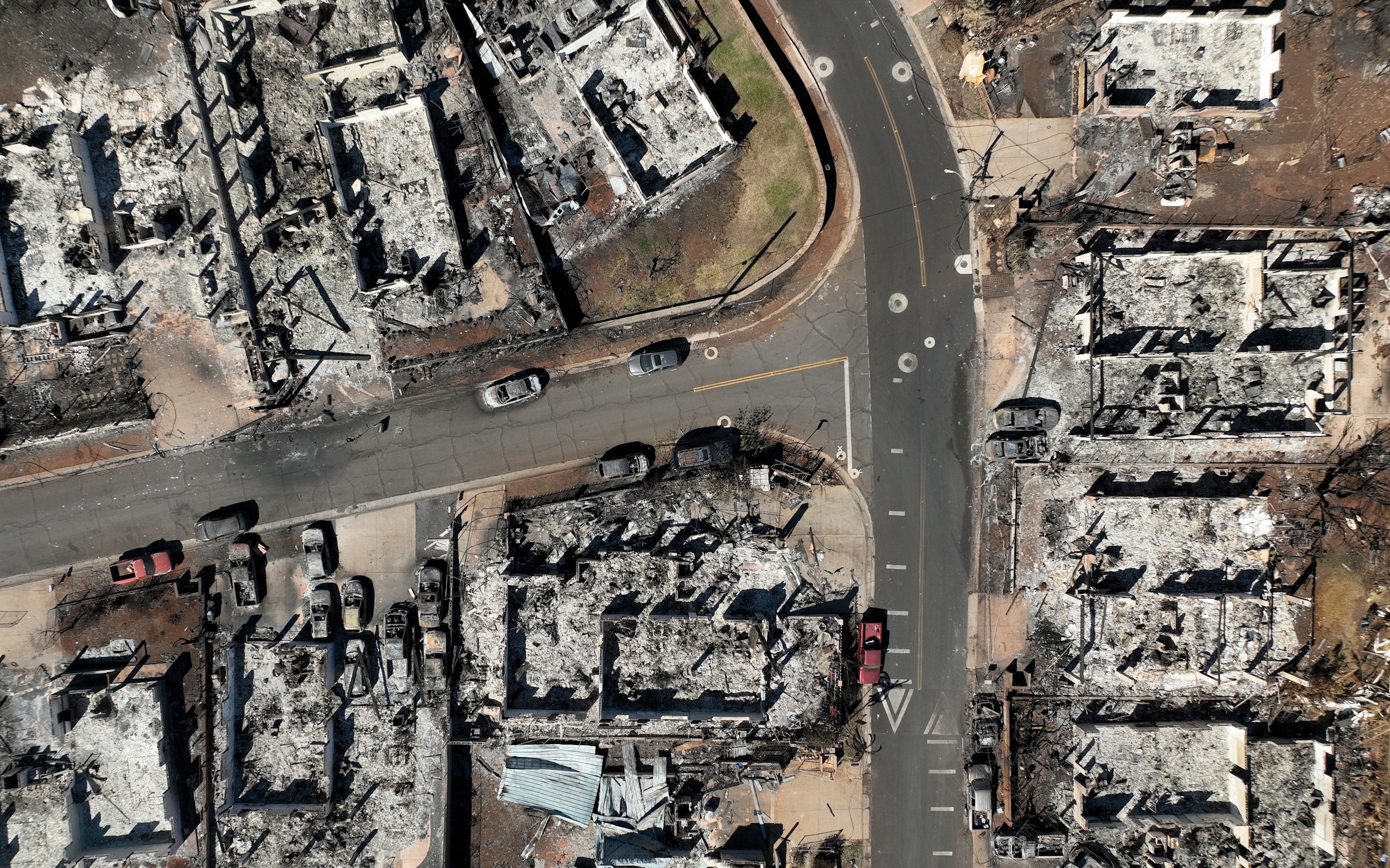 PHOTO: In an aerial view, burned cars and homes are seen a neighborhood that was destroyed by a wildfire on Aug. 17, 2023 in Lahaina, Hawaii. 