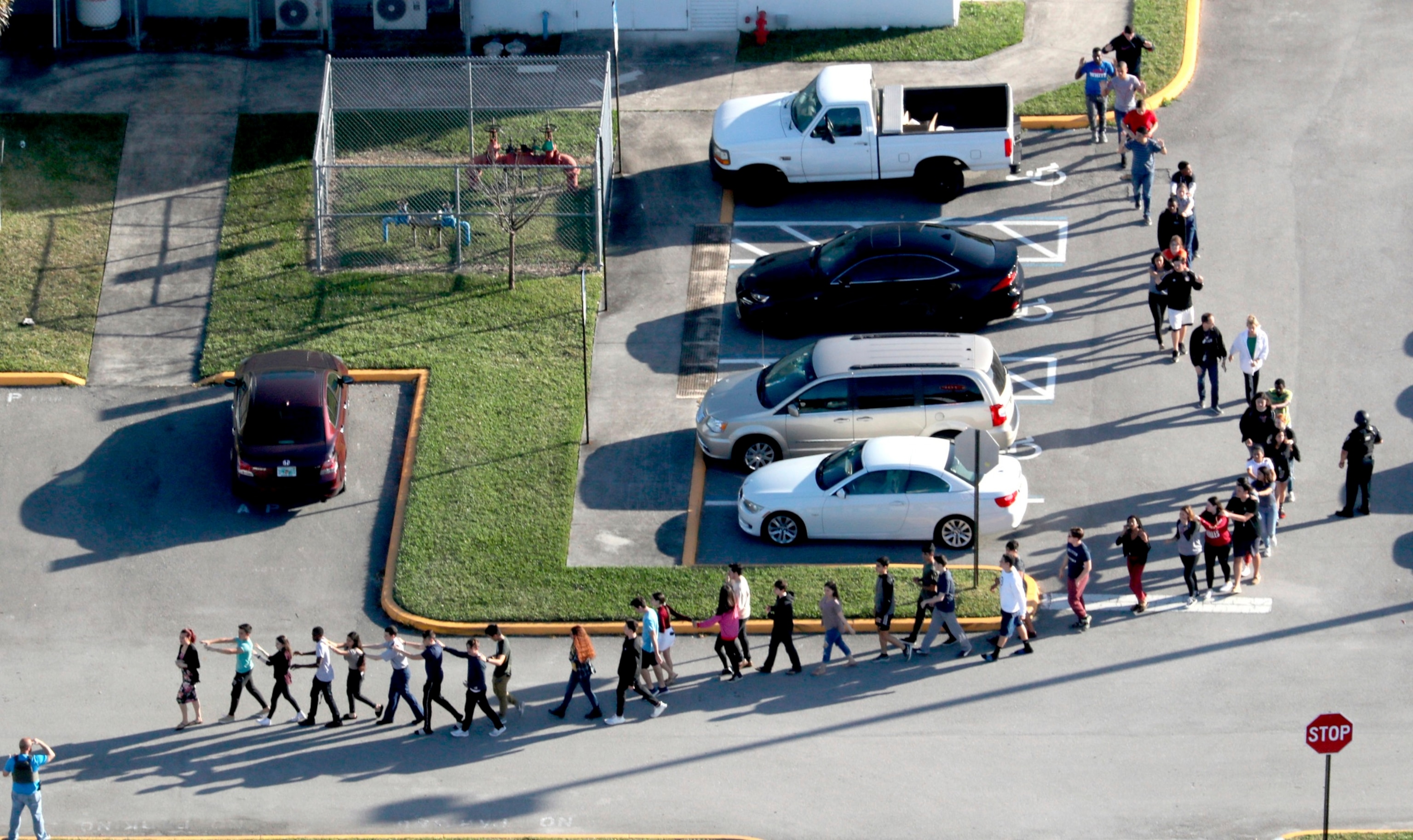 PHOTO: Students are evacuated by police from Marjory Stoneman Douglas High School in Parkland, Fla., Feb. 14, 2018, after a shooter opened fire on the campus.