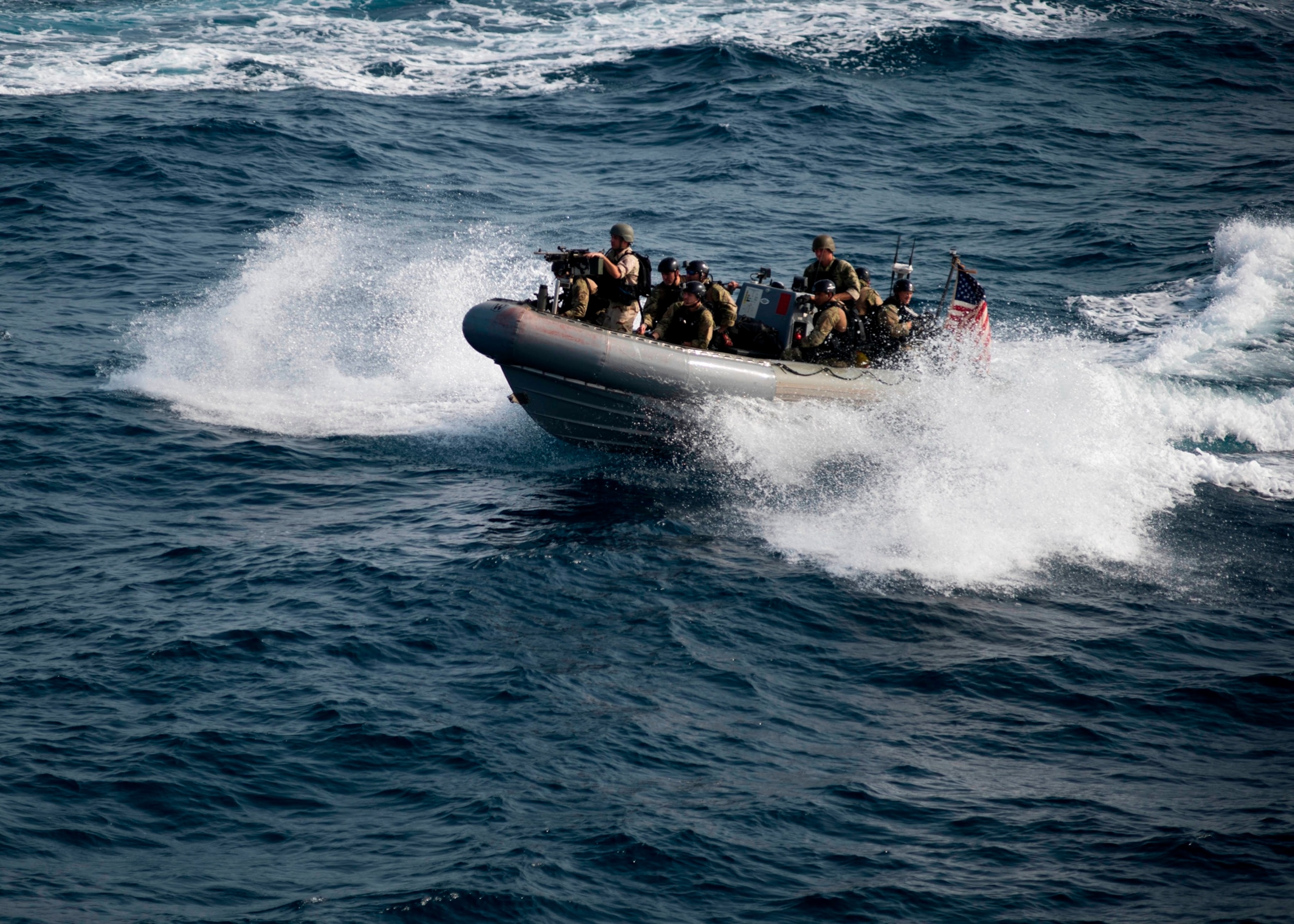 PHOTO: The guided-missile destroyer USS Roosevelt’s (DDG 80) visit, board, search and seizure (VBSS) team rides on a rigid-hull inflatable boat during VBSS operations. 