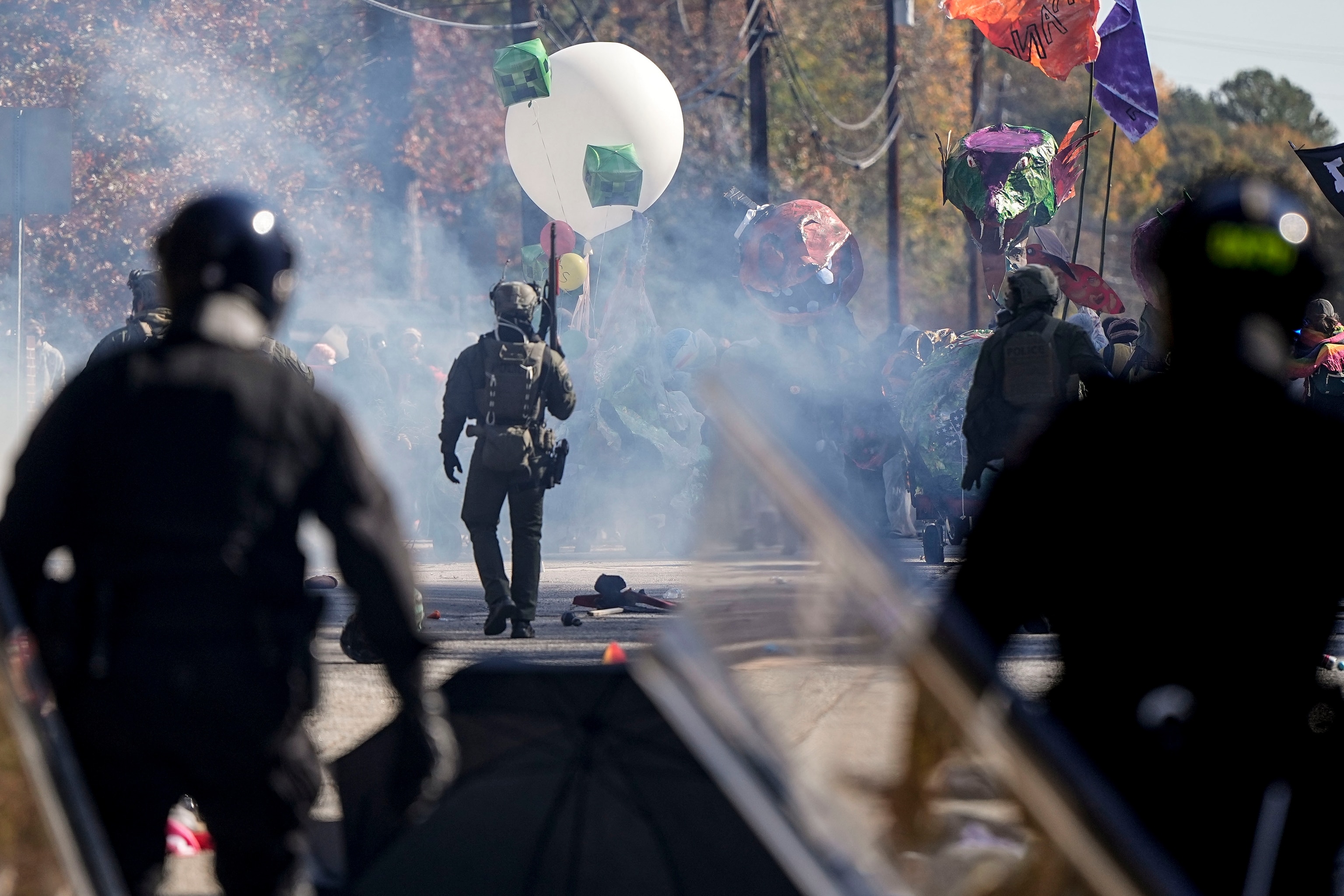 PHOTO: Police officers confront protesters in a gas cloud during a demonstration in opposition to a new police training center, Nov. 13, 2023, in Atlanta