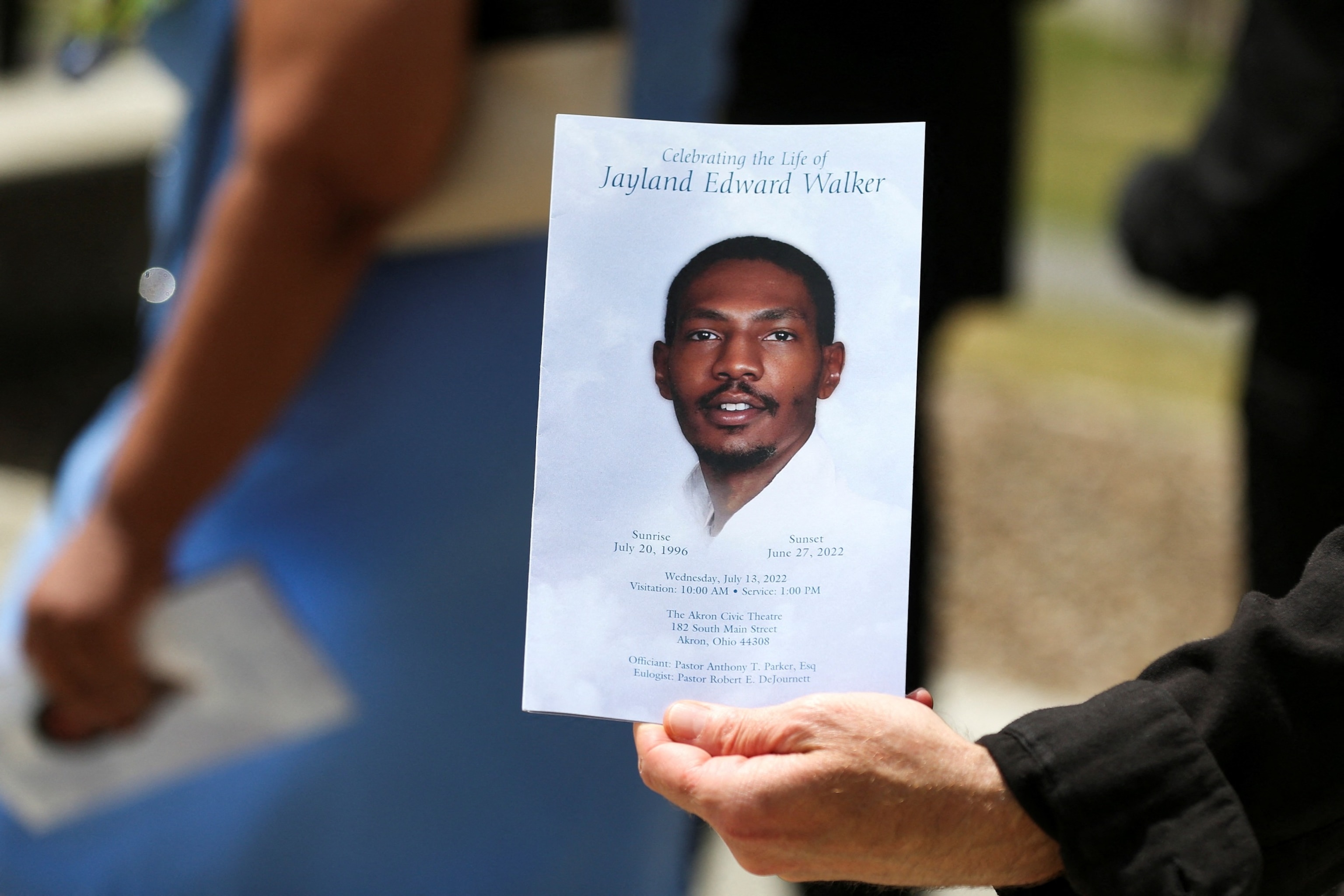 PHOTO: A man holds up the program following the funeral services for Jayland Walker, a 25 year old black man was shot to death by up to eight police officers on June 27, 2022, in Akron, Ohio, July 13, 2022. 