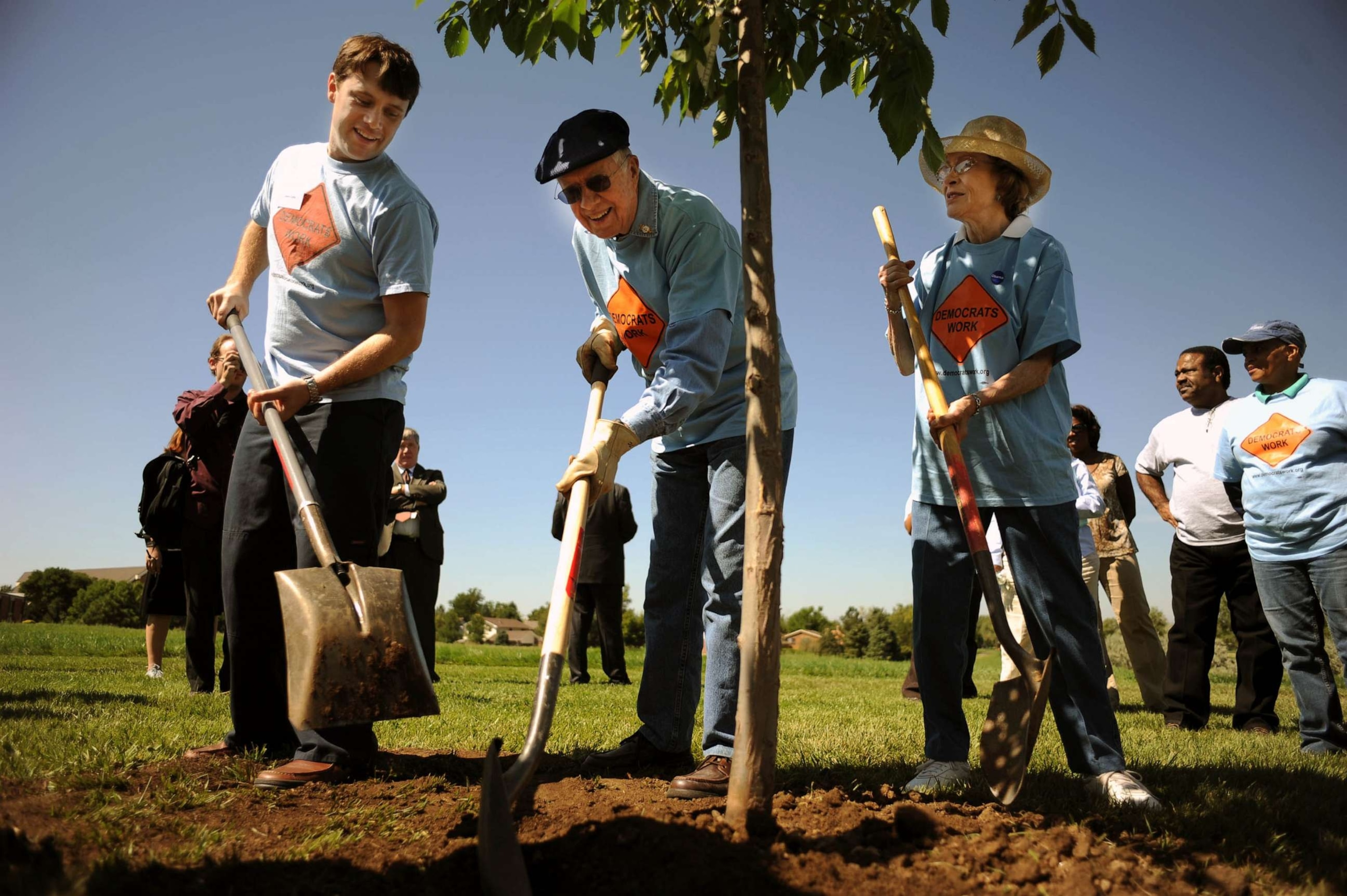 PHOTO: FILE - Former president Jimmy Carter, center, and his wife Rosalyn, right, and their grand son Jason are tree planting during their participating in the day service with the Georgia Delegation at Bicentennial Park in Aurora, Denver.