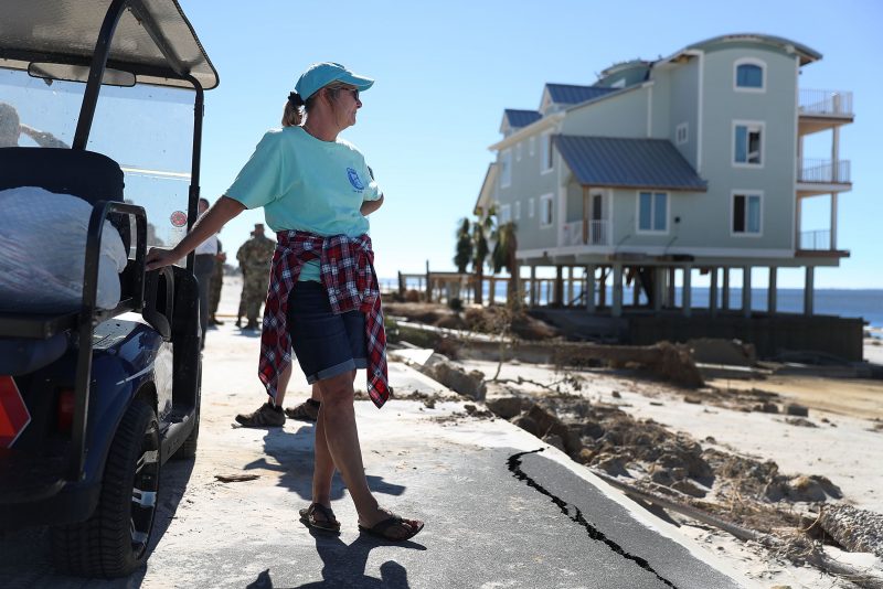 MEXICO BEACH, FL - OCTOBER 12: Angel Smith stands next to a golf cart with some of the items she salvaged from her home that was damaged by Hurricane Michael on October 12, 2018 in Mexico Beach, Florida. Angel said, ' she never thought she would one day have all her belongings in two plastic bags'. The hurricane hit the panhandle area with category 4 winds causing major damage. (Photo by Joe Raedle/Getty Images)