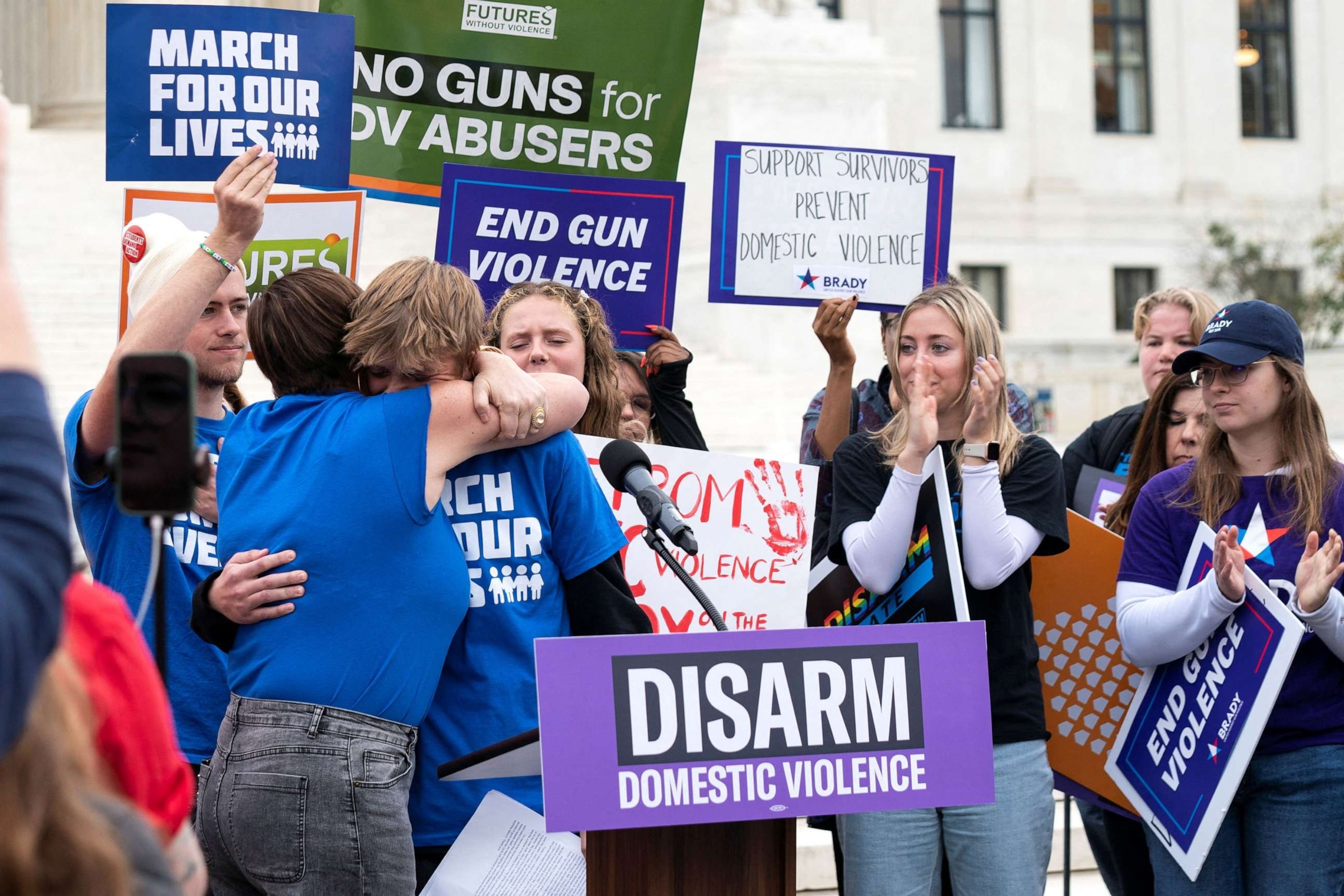 PHOTO: People hug during a demonstration as the Supreme Court considers legality of domestic-violence gun curbs at the Supreme Court in Washington, D.C., Nov. 7, 2023.