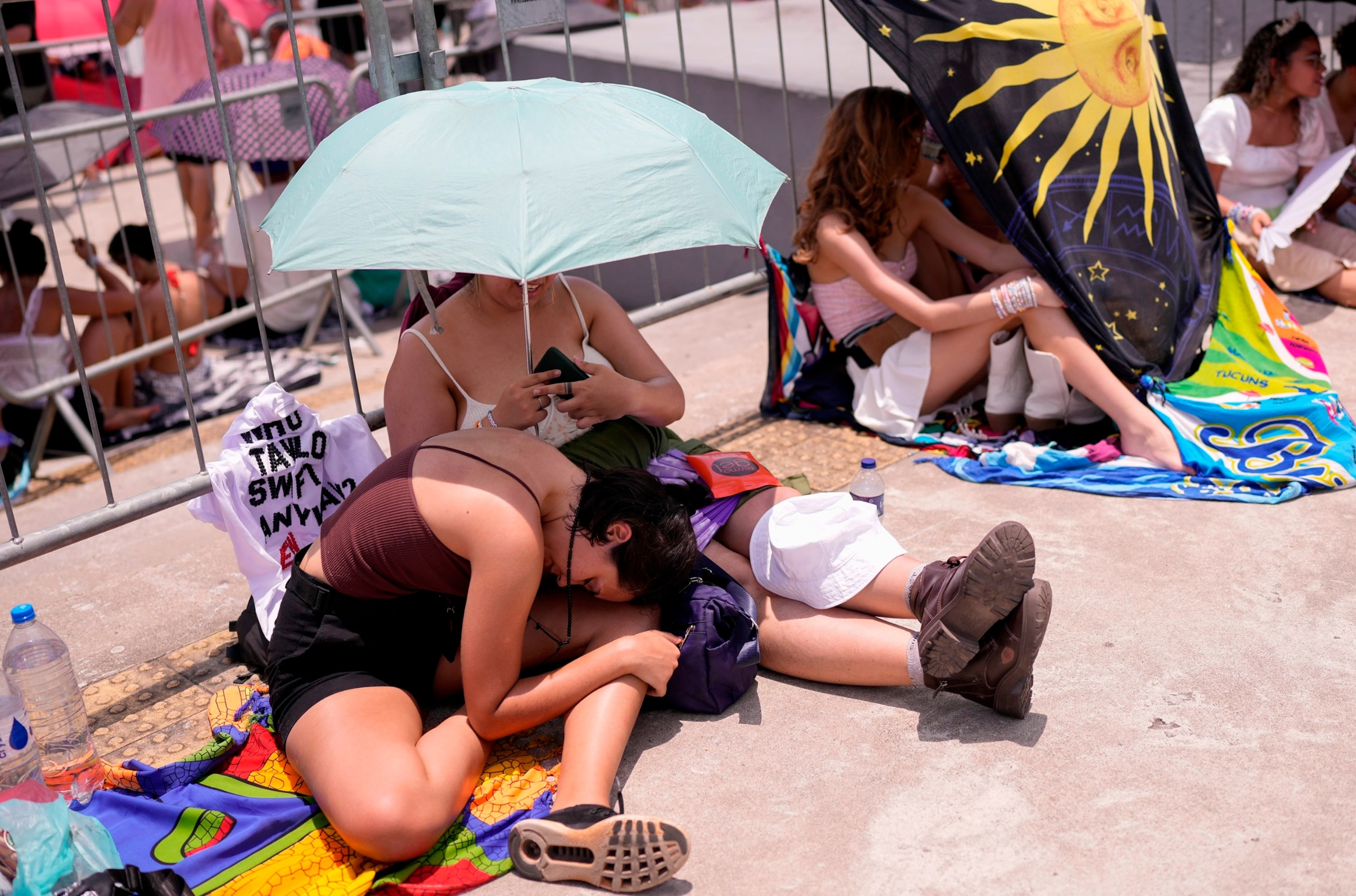 PHOTO: Taylor Swift fans wait for the doors of Nilton Santos Olympic stadium to open for her Eras Tour concert amid a heat wave in Rio de Janeiro, Brazil, on Nov. 18, 2023. 