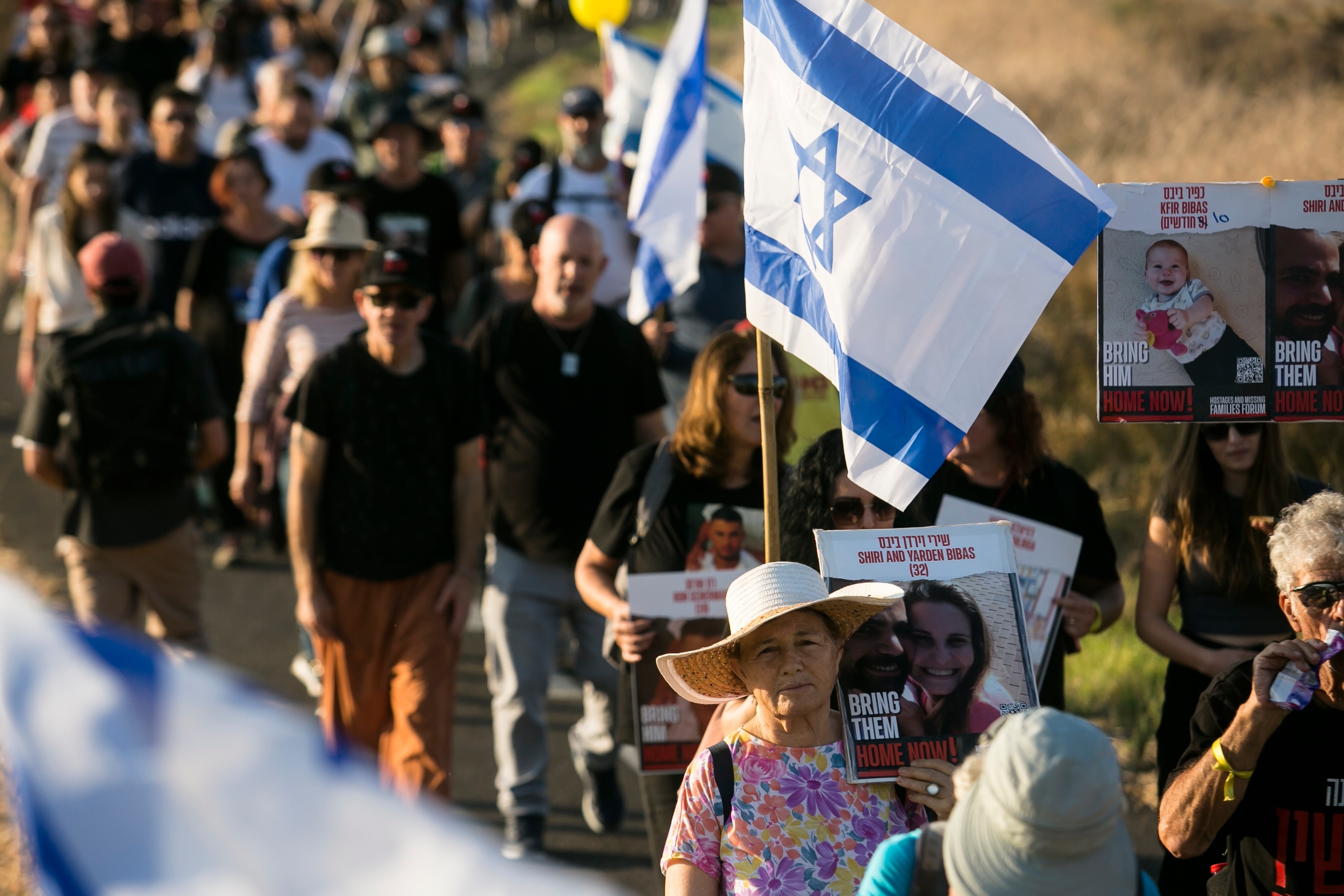 PHOTO: Family members, relatives and supporters hold posters showing hostages as they march to Jerusalem, Nov. 15, 2023 in Beit Hashmonai, Israel.