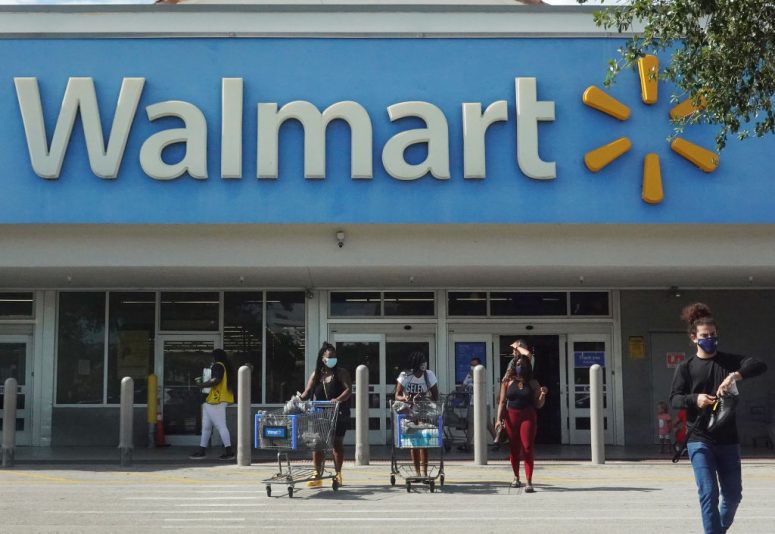 HALLANDALE BEACH, FLORIDA - MAY 18: People wearing protective masks walk from a Walmart store on May 18, 2021 in Hallandale Beach, Florida. Walmart announced that customers who are fully vaccinated against Covid-19 will not need to wear a mask in its stores, unless one is required by state or local laws. The announcement came after the Centers for Disease Control and Prevention said that fully vaccinated people do not need to wear a mask or stay 6 feet apart from others in most cases, whether indoors or outdoors. (Photo by Joe Raedle/Getty Images)