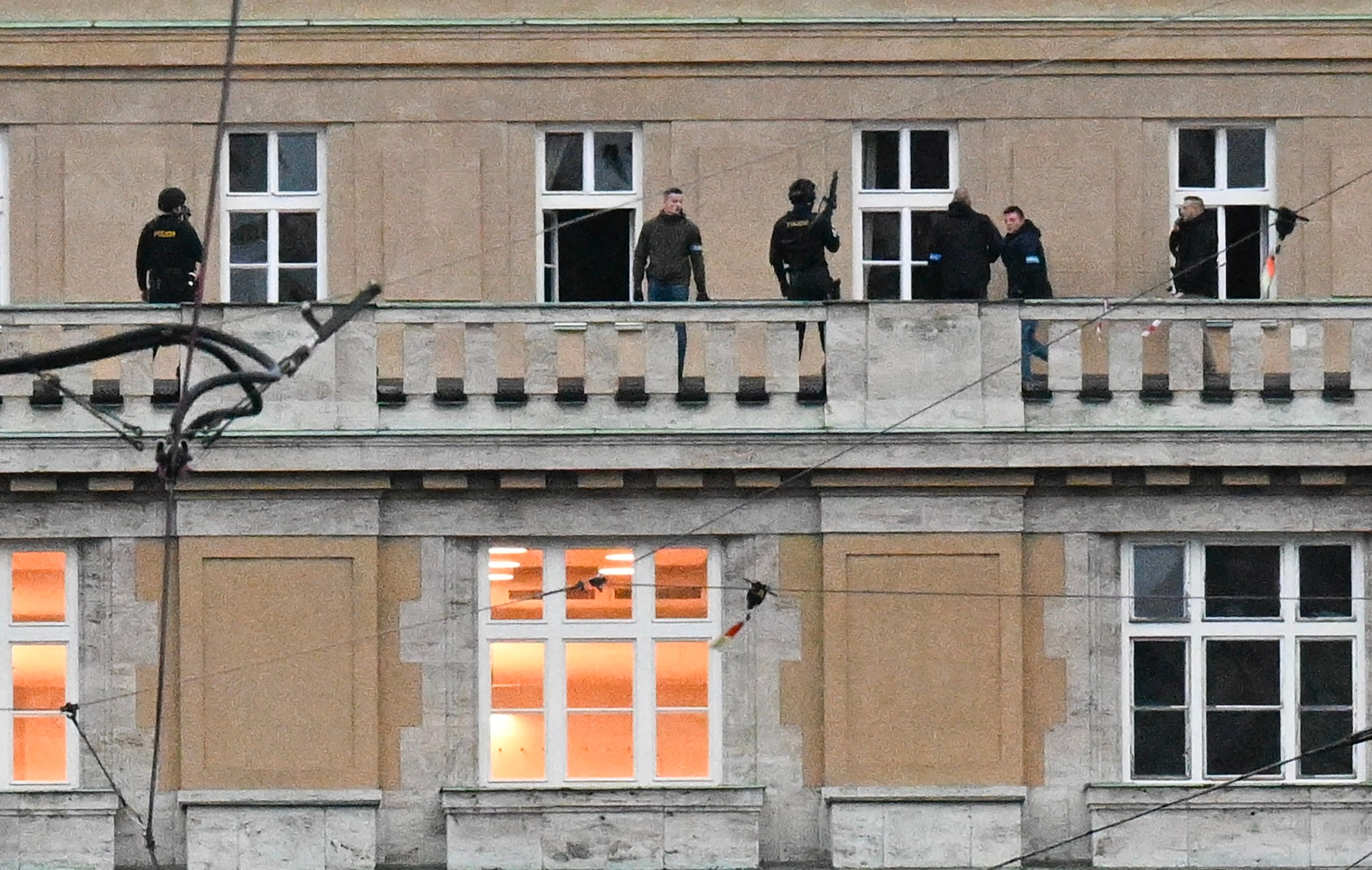 PHOTO: Armed police are seen on the balcony of the university in central Prague, Dec. 21, 2023.