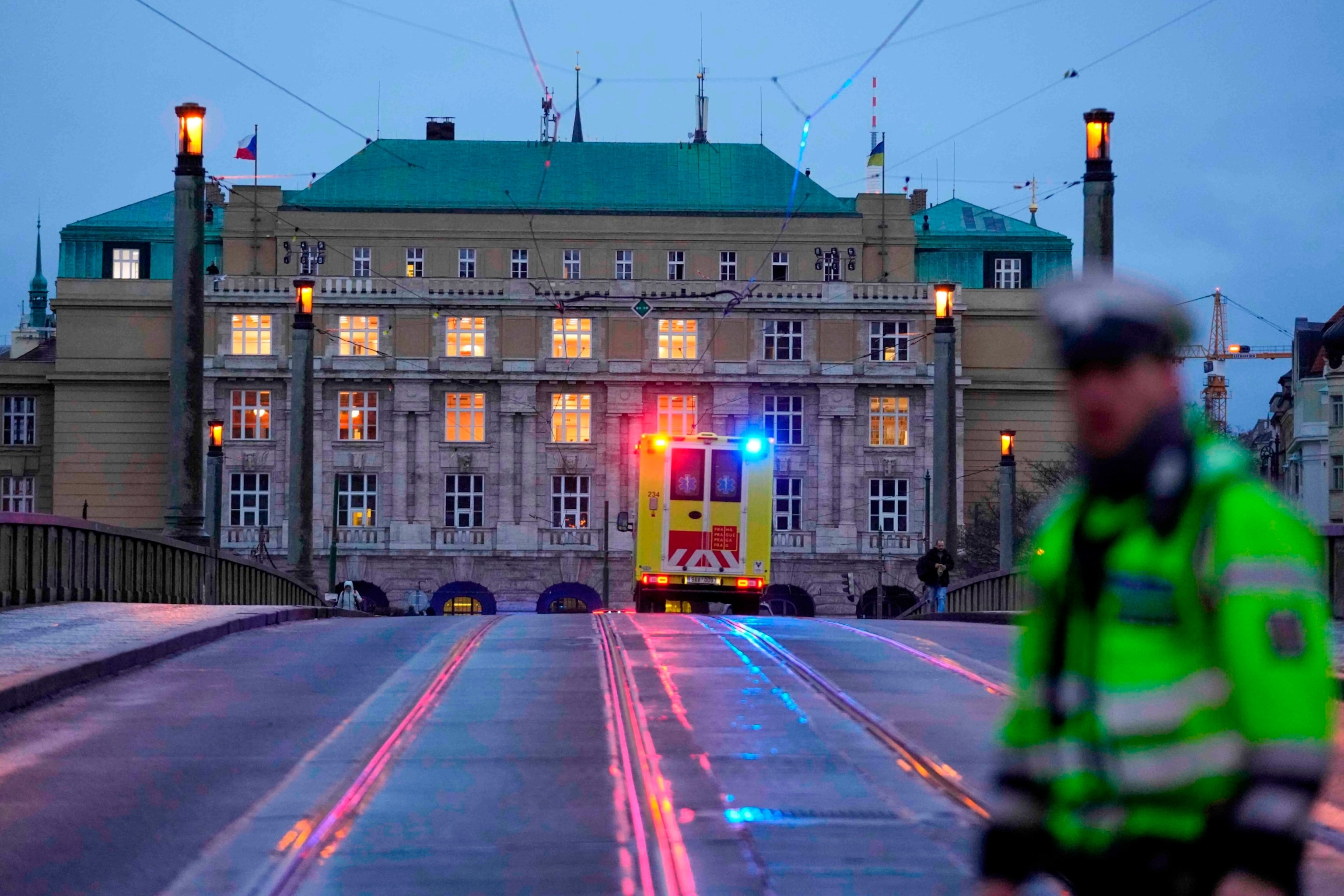 PHOTO: An ambulance drives towards the building of Philosophical Faculty of Charles University in downtown Prague, Czech Republic, Dec. 21, 2023.