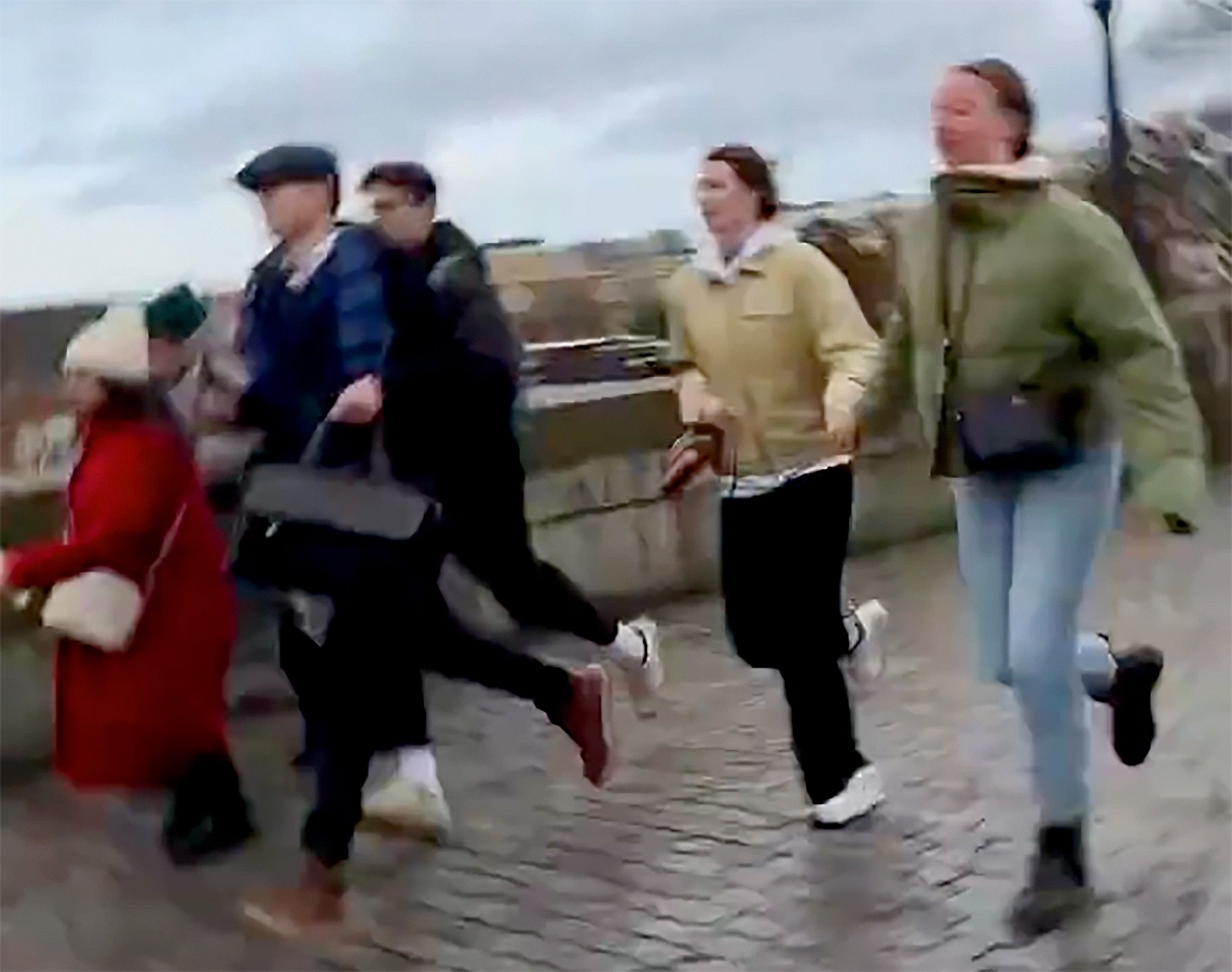 PHOTO: People run from the scene of a shooting in downtown Prague, Czech Republic, Dec. 21, 2023.