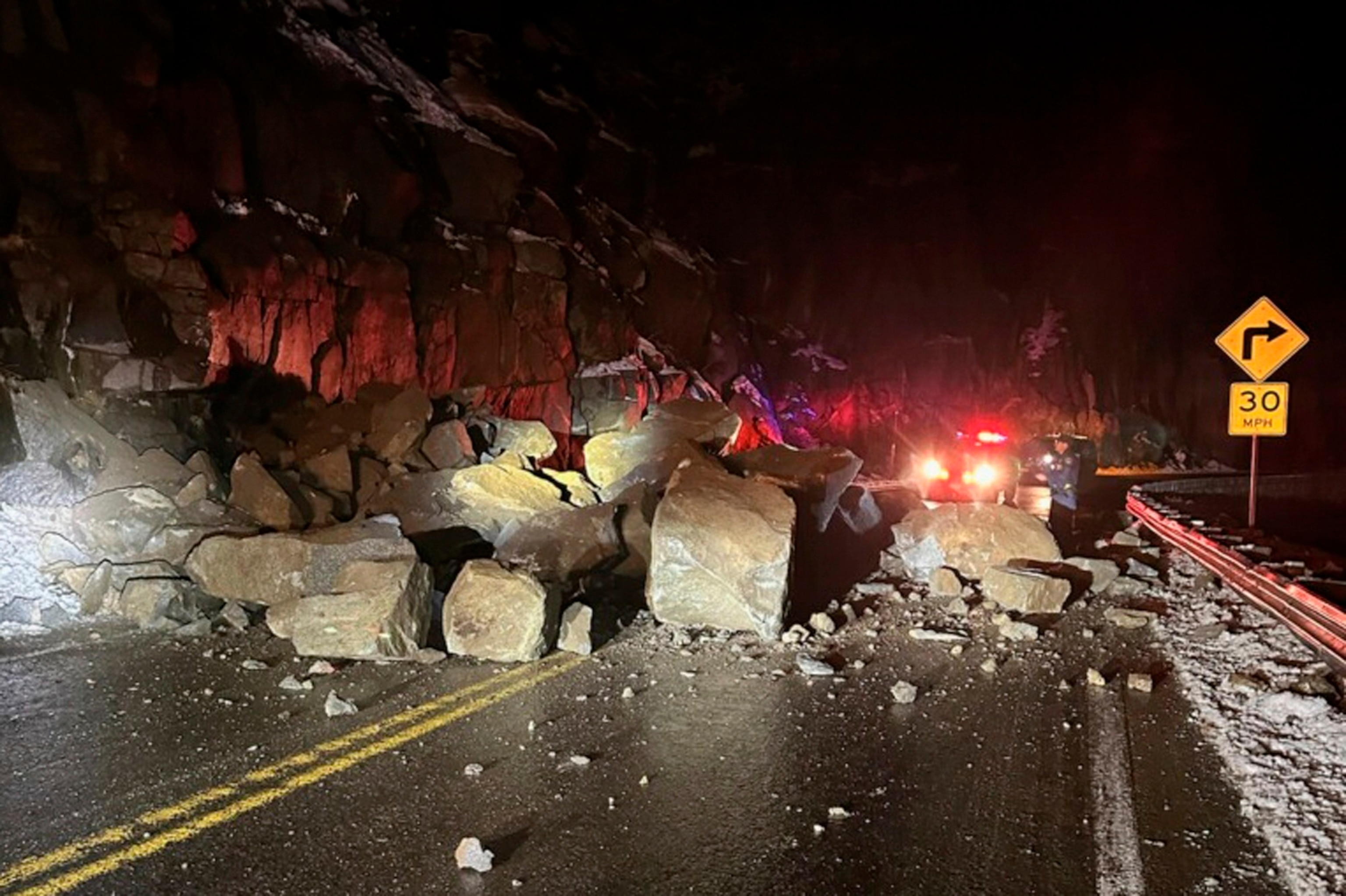 In this photo provided by the California Highway Patrol, fallen boulders from Echo Summit block U.S. Highway 50 in El Dorado County, Calif., early Wednesday, Dec. 20, 2023.