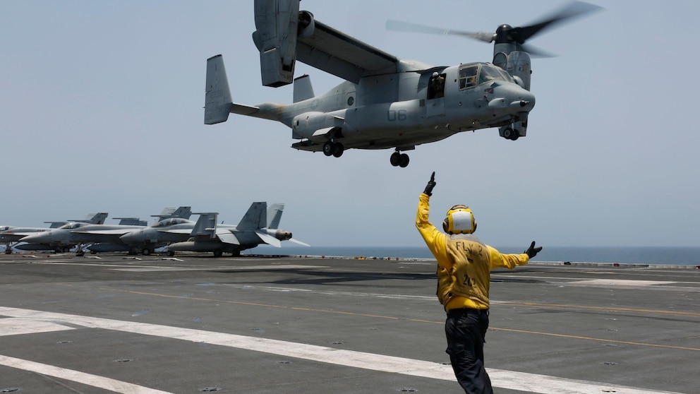 FILE -In this image provided by the U.S. Navy, Aviation Boatswain's Mate 2nd Class Nicholas Hawkins, signals an MV-22 Osprey to land on the flight deck of the USS Abraham Lincoln in the Arabian Sea on May 17, 2019. When the U.S. military took the extraordinary step of grounding its fleet of V-22 Ospreys this week, it wasn't reacting just to the recent deadly crash of the aircraft off the coast of Japan. The aircraft has had a long list of problems in its short history. (Mass Communication Specialist 3rd Class Amber Smalley/U.S. Navy via AP)