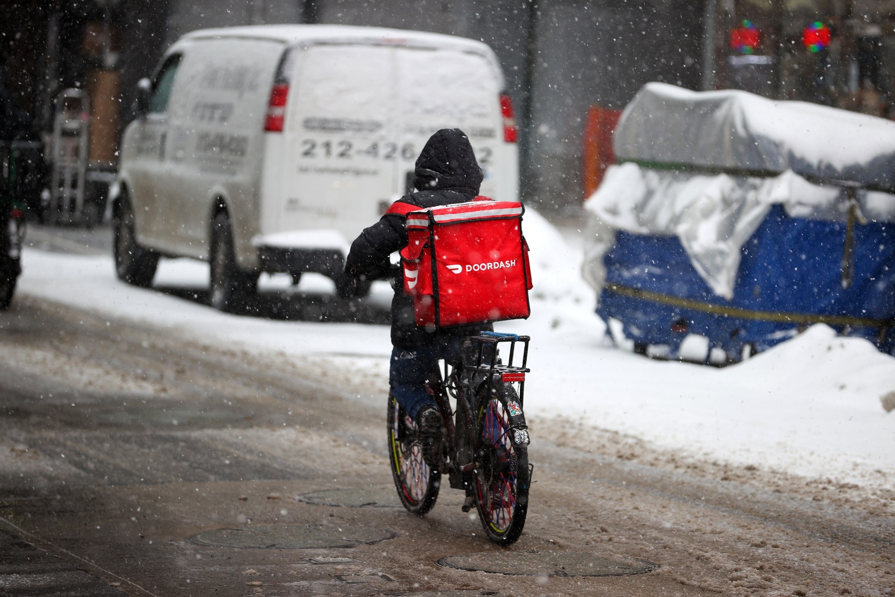 PHOTO: In this Feb. 18, 2021, file photo, a food delivery worker is seen as snowfall blankets the area in New York.