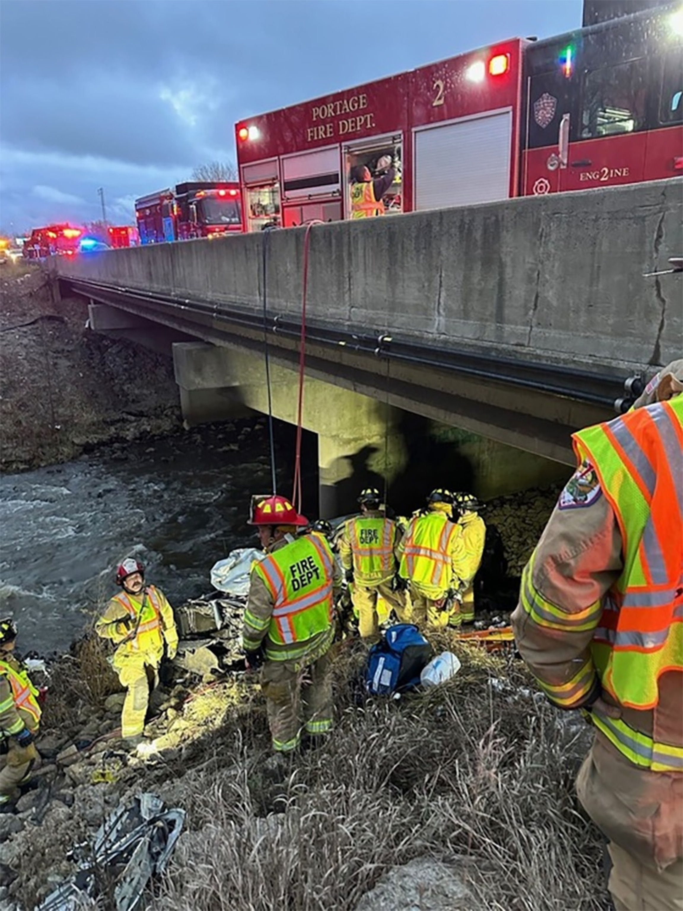 PHOTO: Crews retrieve a man from a crashed vehicle in Portage, Indi., on Dec. 26, 2023. 