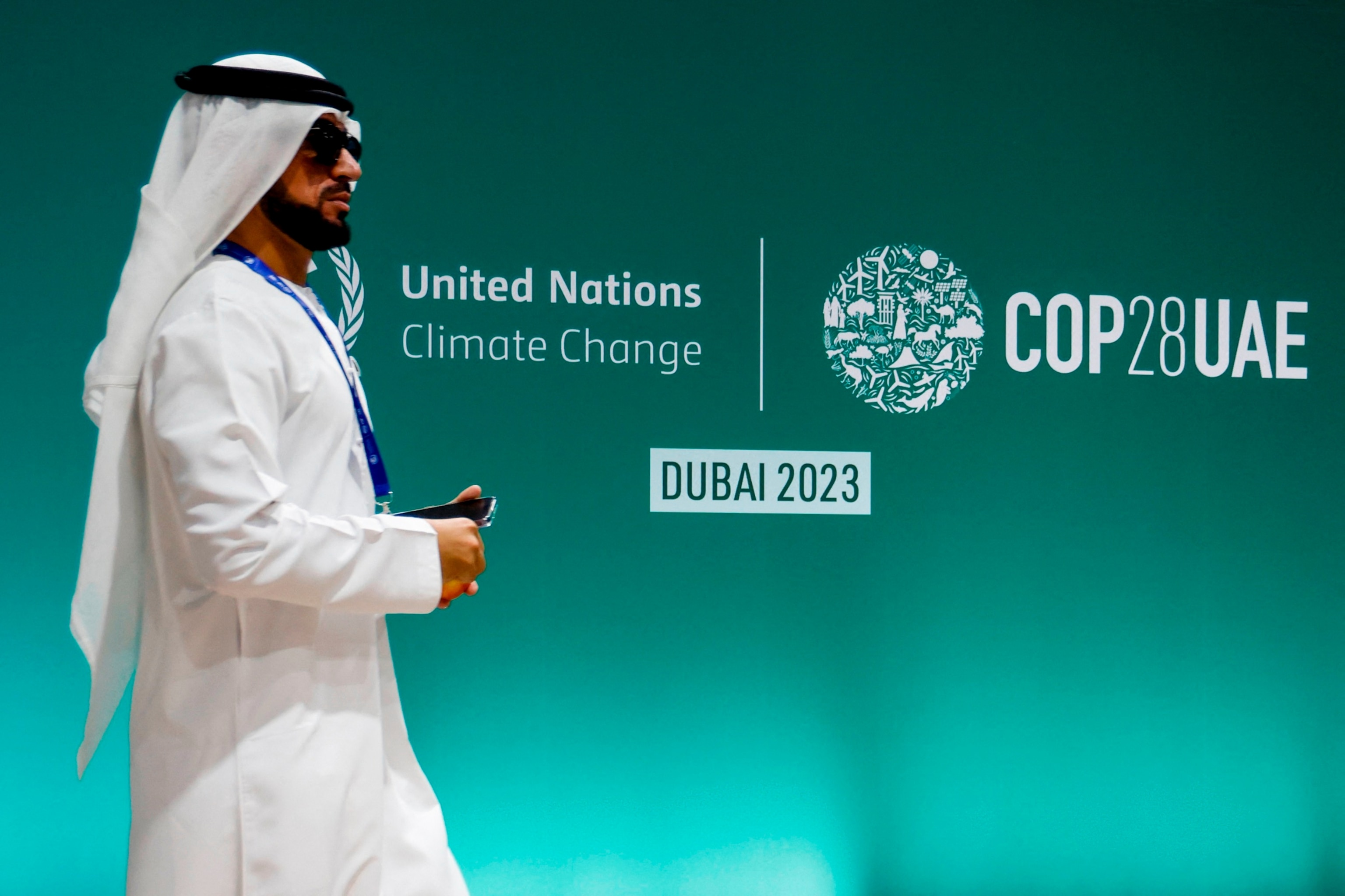 PHOTO:A man walks past a COP28 sign during the United Nations climate summit in Dubai, United Arab Emirates on Dec. 1, 2023. 